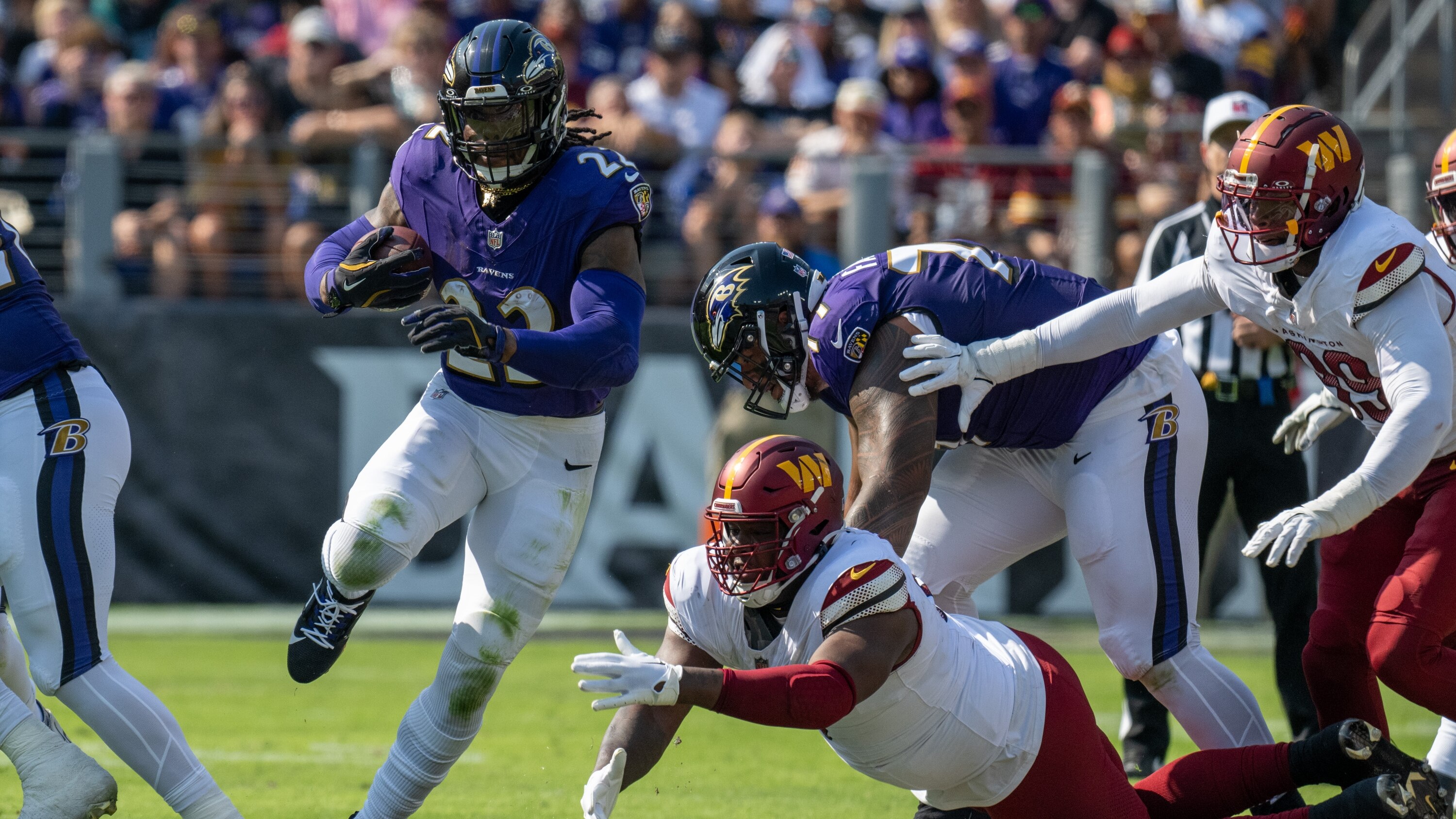 Baltimore Ravens running back Derrick Henry (22) finds a hole for a gain against the Commanders. The Ravens beat the Commanders 30-23 at M&T Bank Stadium on Sunday, October 13.