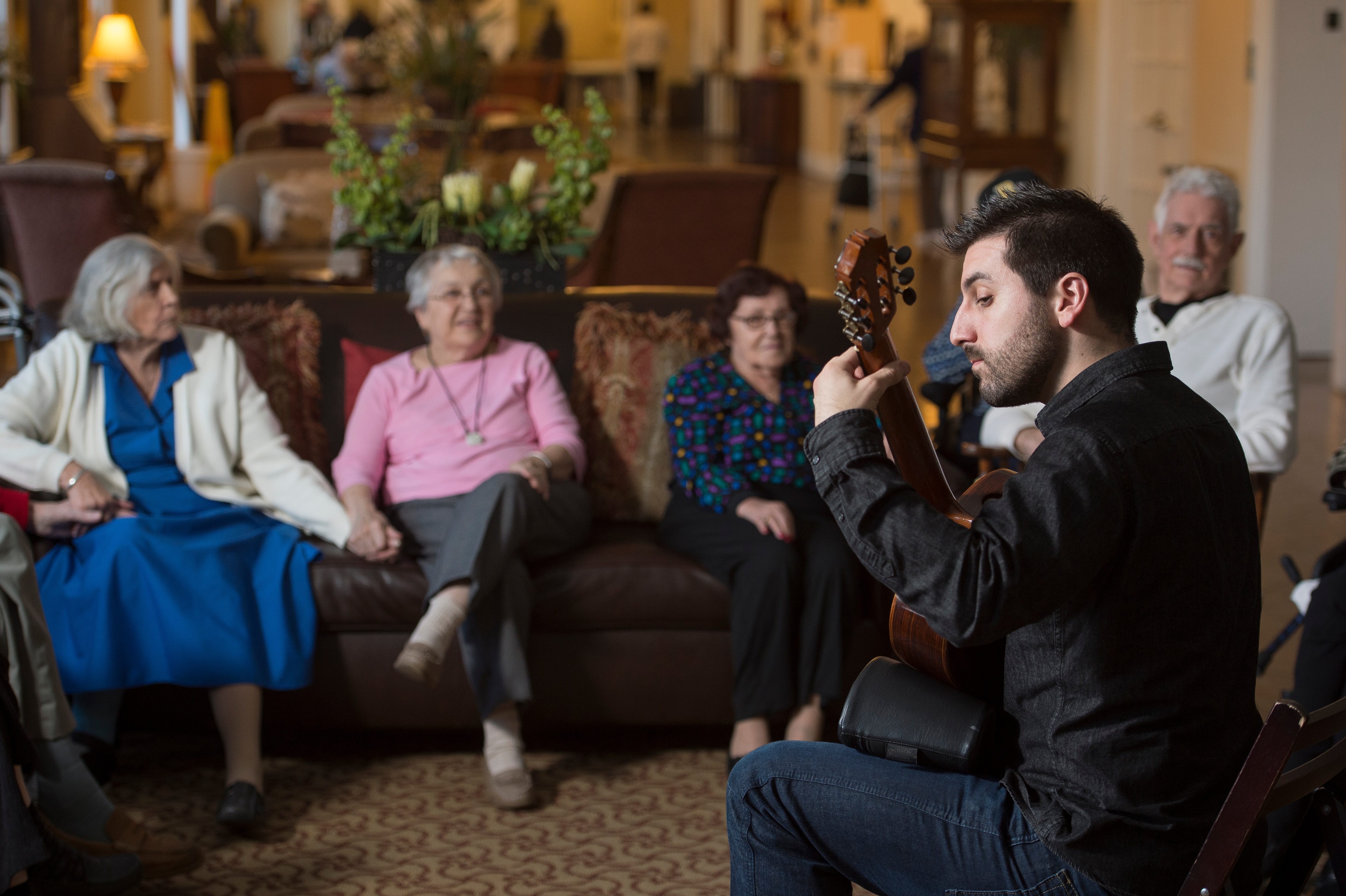 The first Peabody Institute musician-in-residence — guitarist Julien Xuereb —performs in lobby of Springwell Senior Living in 2015.