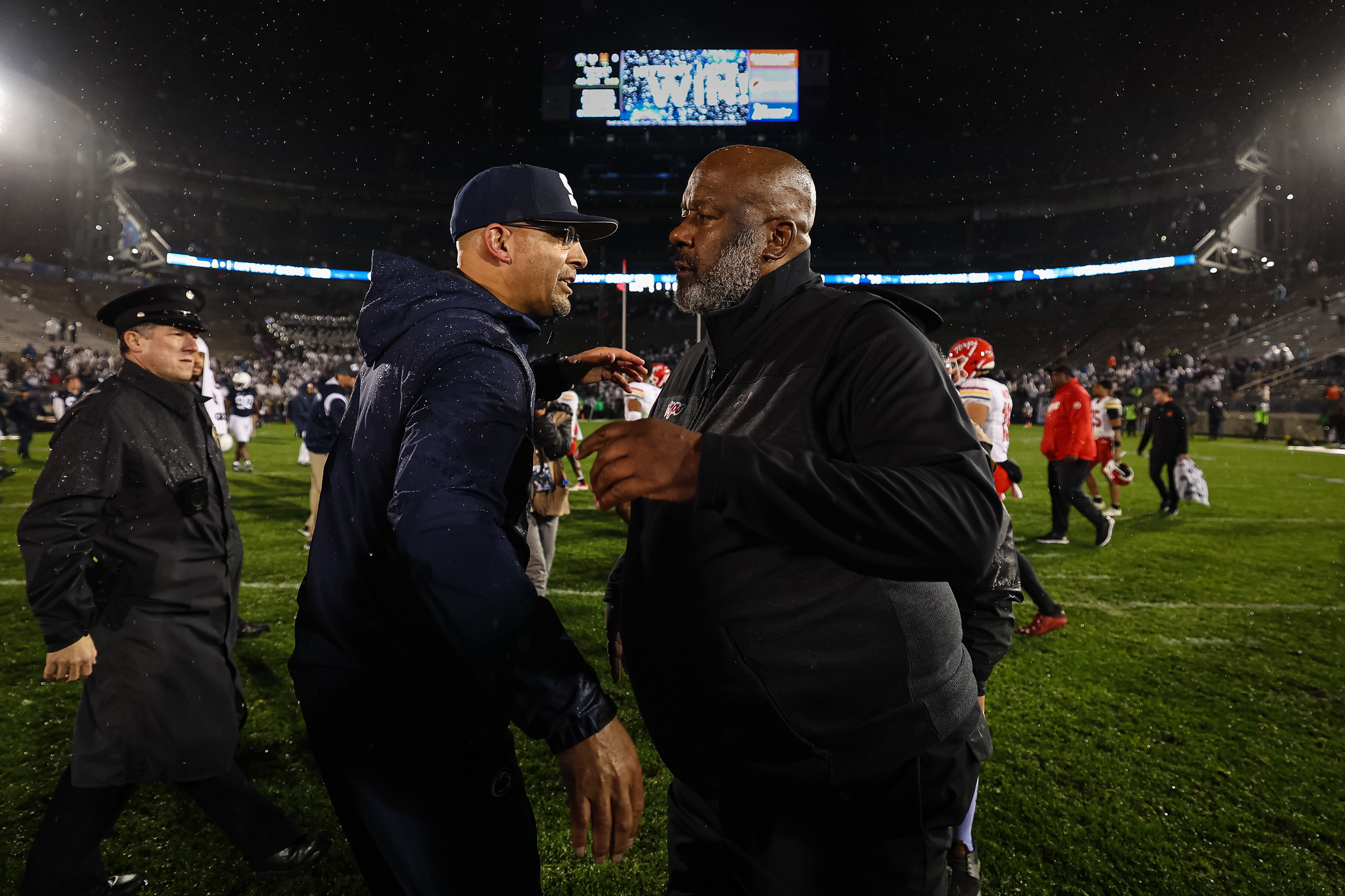 Head coaches James Franklin of Penn State (left) and Michael Locksley of Maryland chat on the field after last season's game at Penn State.