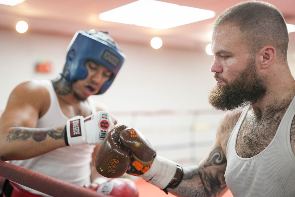Boxers Tyler Langer, right, bumps gloves with Isaiah Johnson before they spar in the ring at the Mack Lewis Boxing Gym in Baltimore, Md. on Tuesday, April 14, 2026.