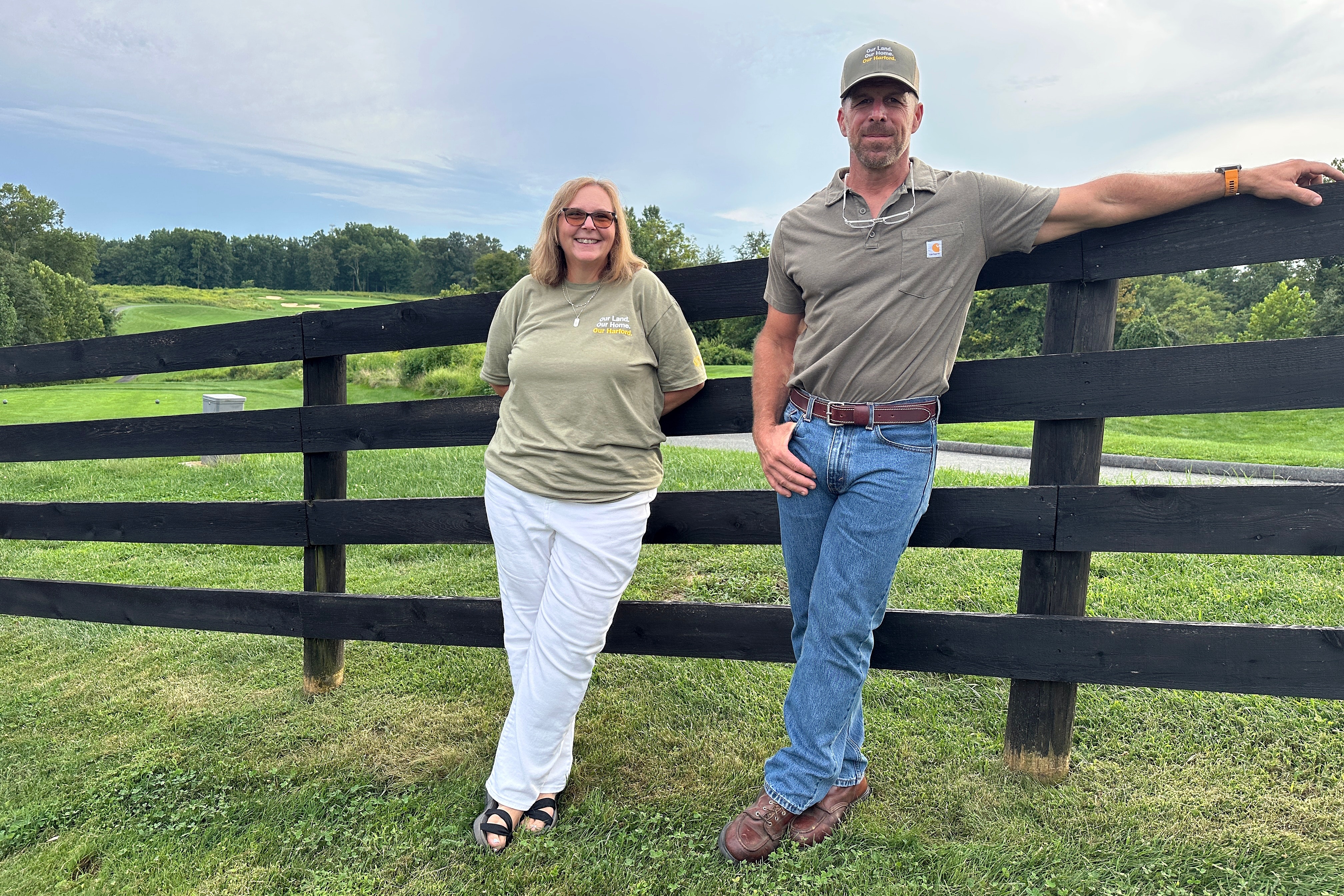 FRIDAY. SEPTEMBER 4, 2026 - Bryan Cornell and Krissy Flatau pose along a fence at Cornell’s 17-acre Harford County property, which abuts a golf course where the owner has proposed building a hyperscale data center campus. Cornell and Flatau's grassroots movement pushed local lawmakers to enact Maryland’s most restrictive data center ban to date.