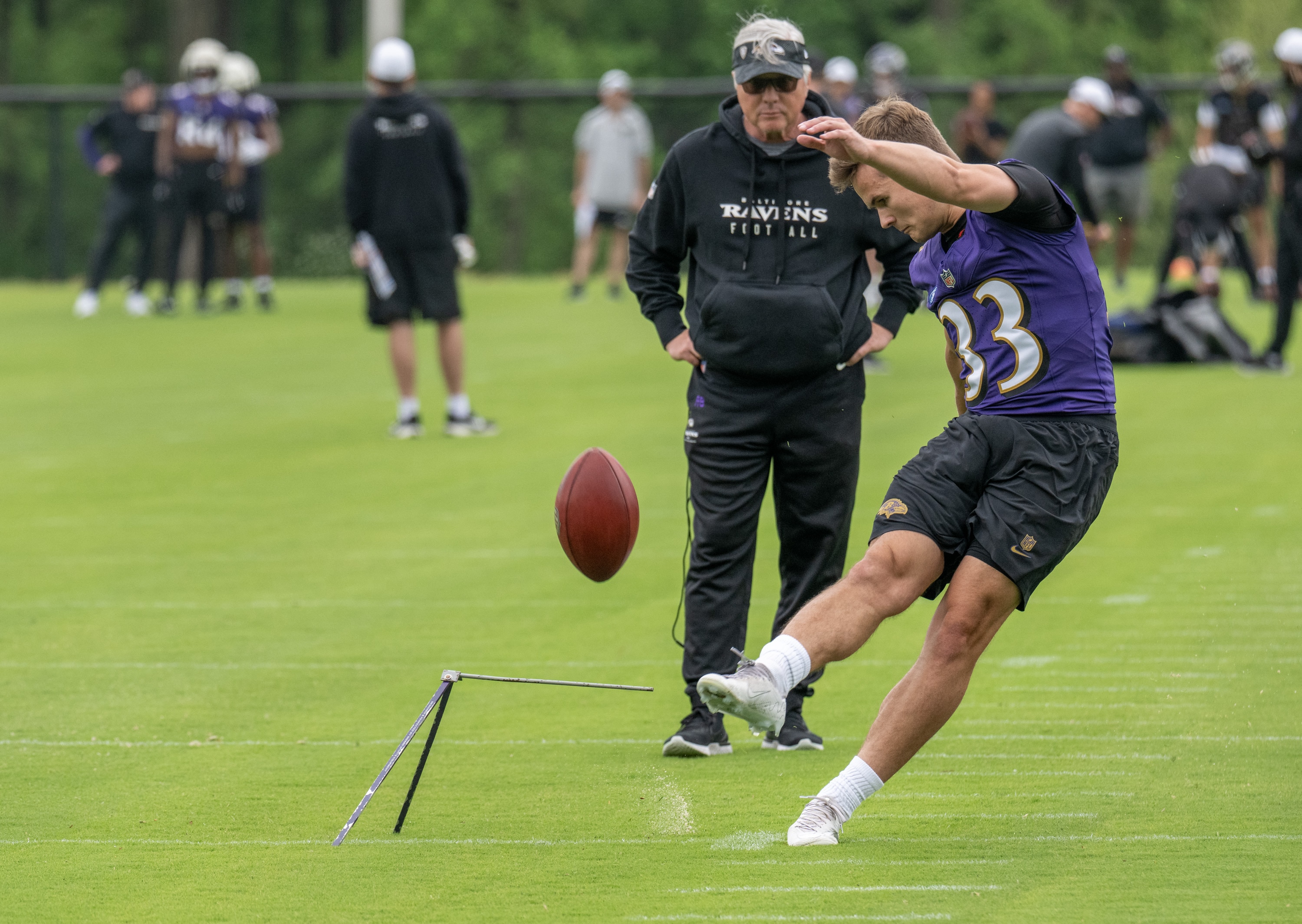 Ravens rookie kicker Tyler Loop, joined by special teams coach Randy Brown, kicks during practice at a rookie mini-camp in Owings Mills on Sunday.