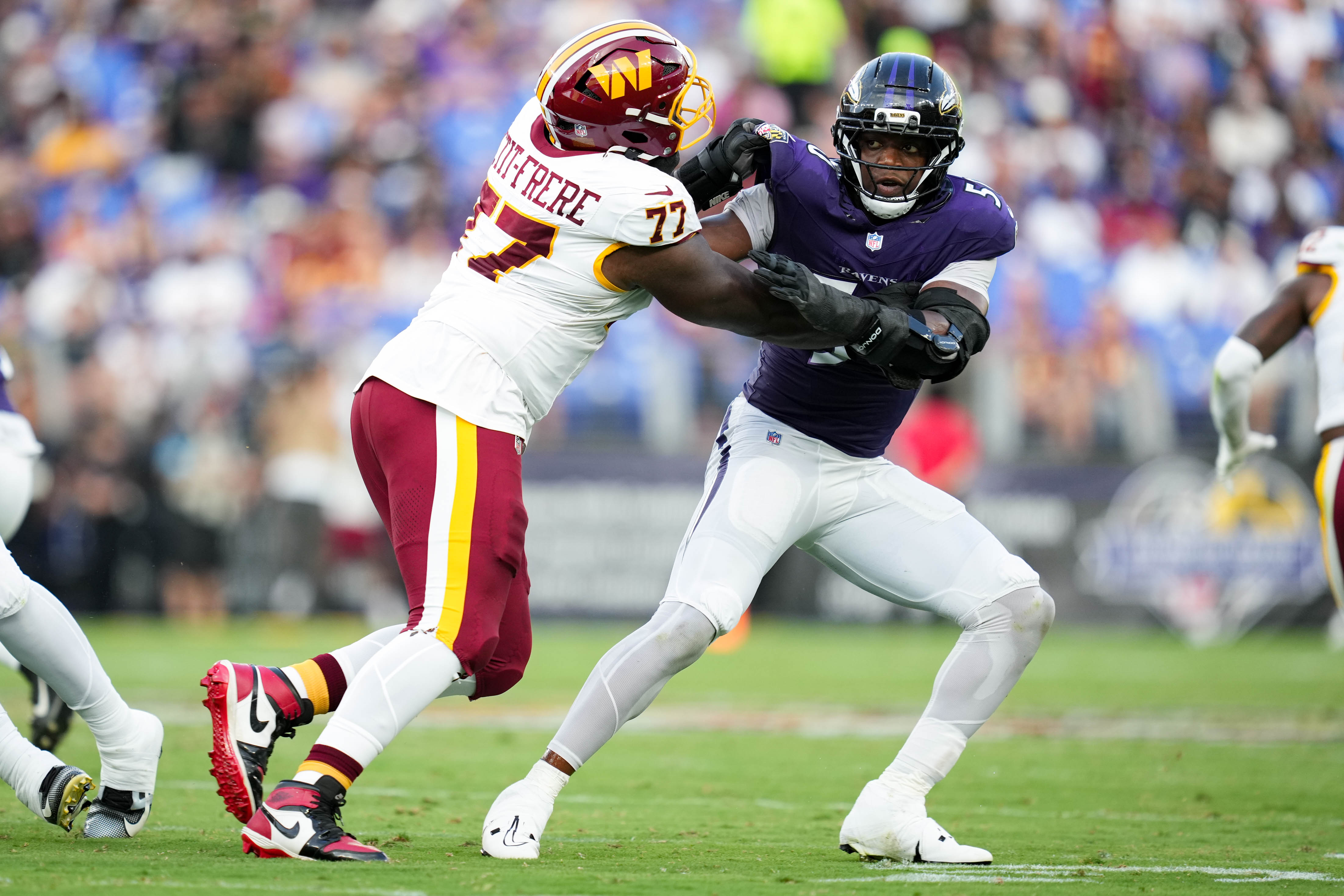 Ravens linebacker Adisa Isaac battles Commanders offensive tackle Nicholas Petit-Frere during Friday night’s preseason game.
