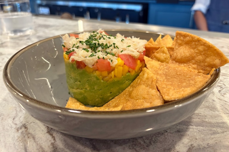 The Crab Tower is stacked with avocado, tomato, mango, crabmeat and wasabi-honey vinaigrette, and is served with house-made tortilla chips.