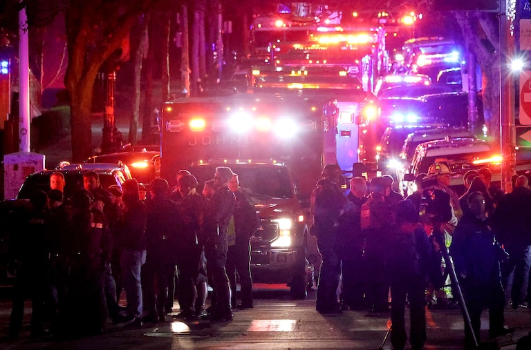 Emergency personnel gather on Waterman Street at Brown University in Providence, R.I., on Saturday, during the investigation of a shooting.