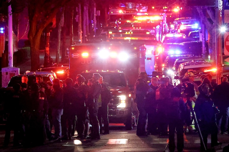 Emergency personnel gather on Waterman Street at Brown University in Providence, R.I., on Saturday, during the investigation of a shooting.