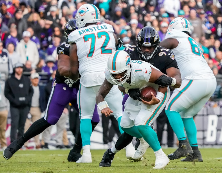 Baltimore Ravens defensive tackle Nnamdi Madubuike (92) sacks Miami Dolphins quarterback Tua Tagovailoa (1) during the third quarter at M&T Bank Stadium on Sunday, Dec. 31, 2023.
