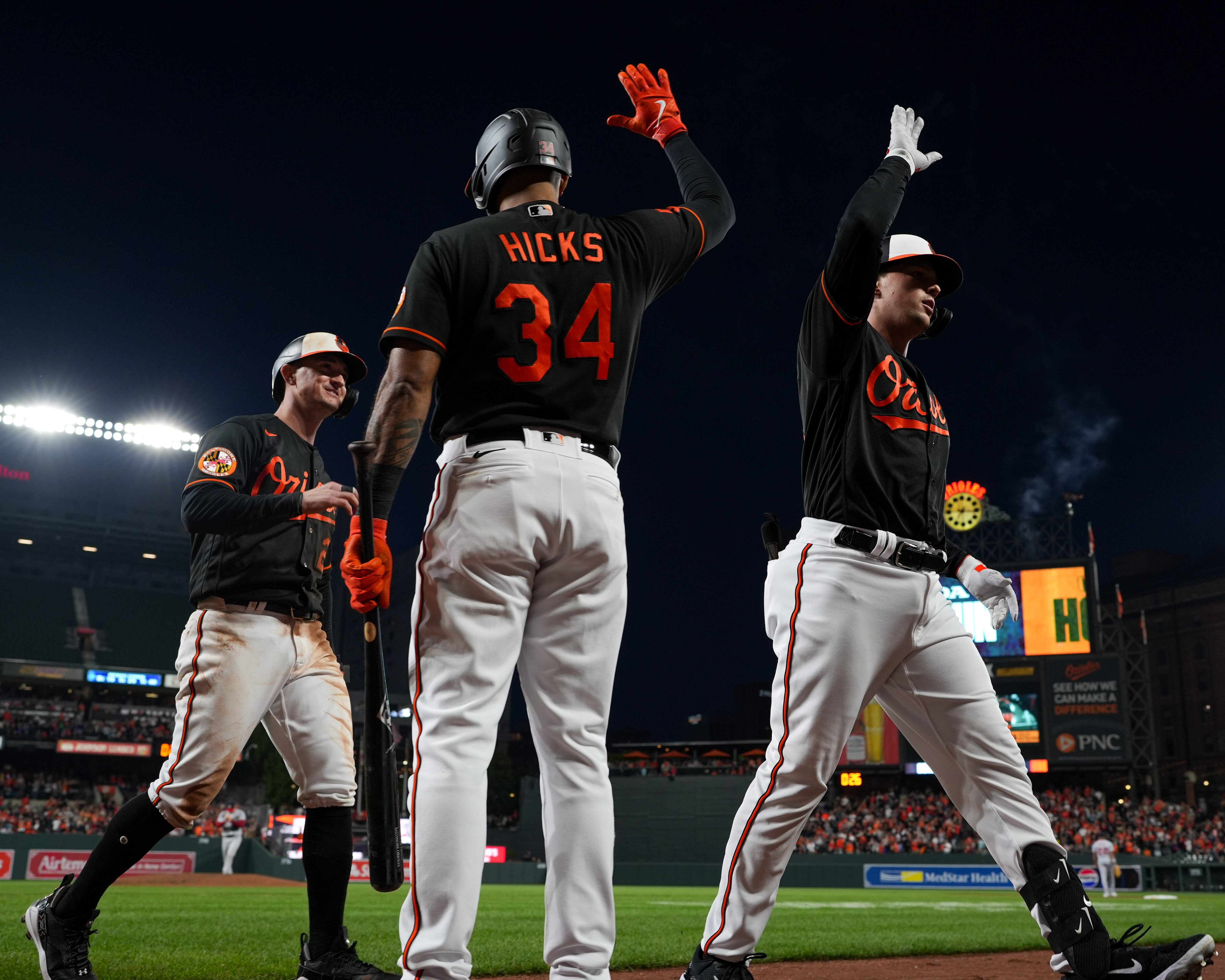 Baltimore Orioles catcher Adley Rutschman (35) celebrates with left fielder Austin Hays (21) and center fielder Aaron Hicks (34) after hitting a two-run homer in the third inning of a baseball game against the Washington Nationals on Wednesday, Sept. 27, 2023.