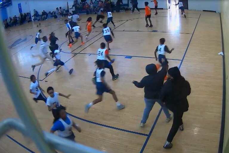 A still from gym security camera footage shows the first moments of an altercation at a Leith Walk Elementary Middle School basketball game on March 6, 2023 between a player's father and one of the team's coaches.