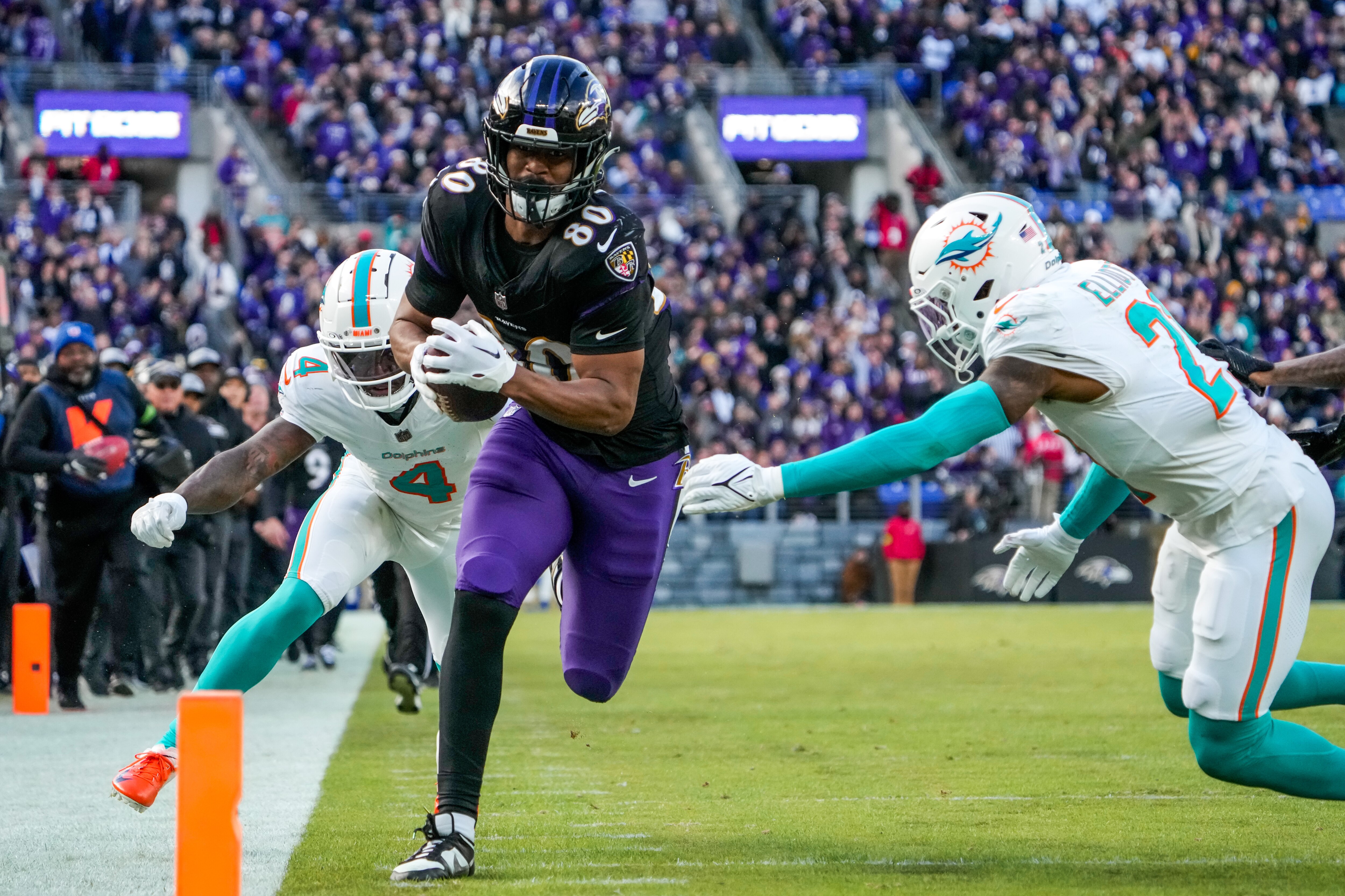 Ravens tight end Isaiah Likely finishes a 35-yard receiving touchdown late in the second quarter Sunday against the Miami Dolphins.