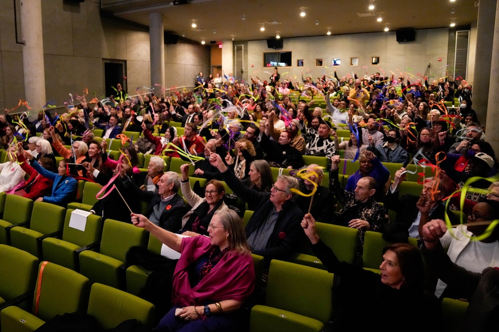 Attendees wave ribbons in the air at the conclusion of a commemorative event recognizing MICA’s bicentennial anniversary celebration at Falvey Hall on MICA’s campus in Baltimore, Md., on Wednesday, January 21, 2026.