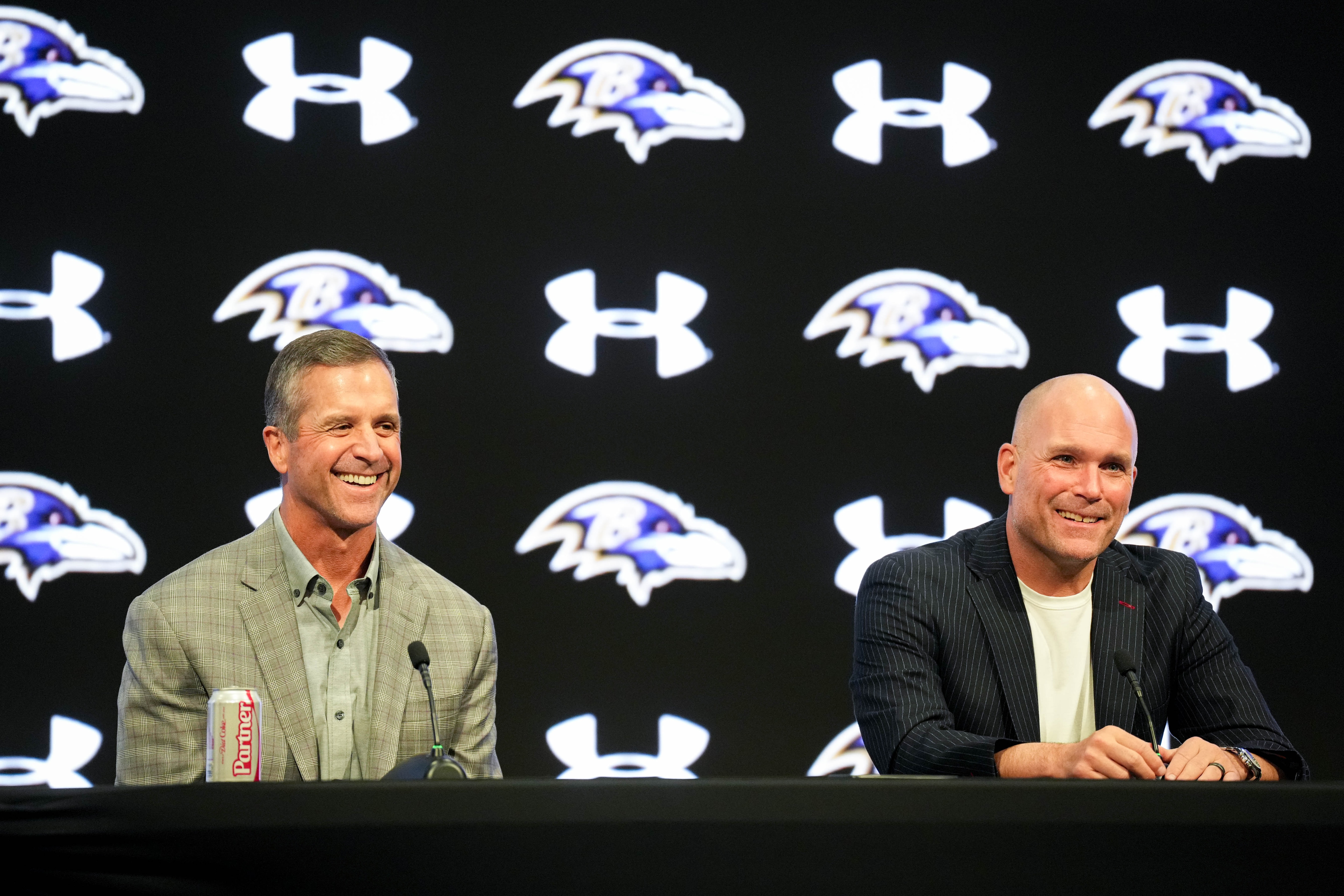 Ravens general manager Eric DeCosta, right, and coach John Harbaugh take questions at the team’s predraft news conference.