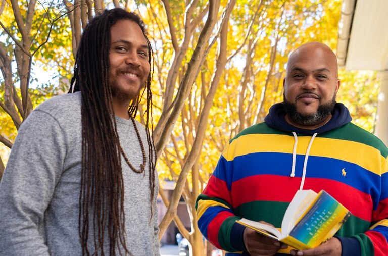 Atman Smith, left, and his brother Ali Smith, two of the authors of Let Your Light Shine, stand in front of their Baltimore office. The book comes out Tuesday, October 18.