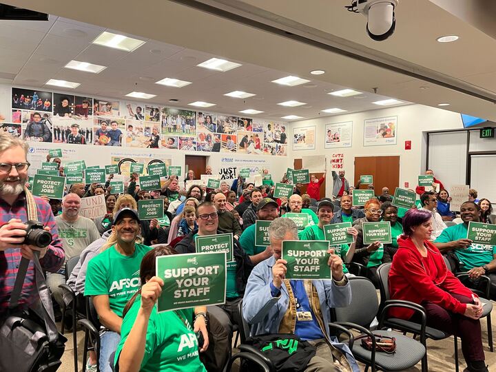 Members of the American Federation of State, County and Municipal Employees Local 1899 chapter wore green t-shirts and held signs at the Howard County Board of Education budget public hearing on Monday, Feb. 26.