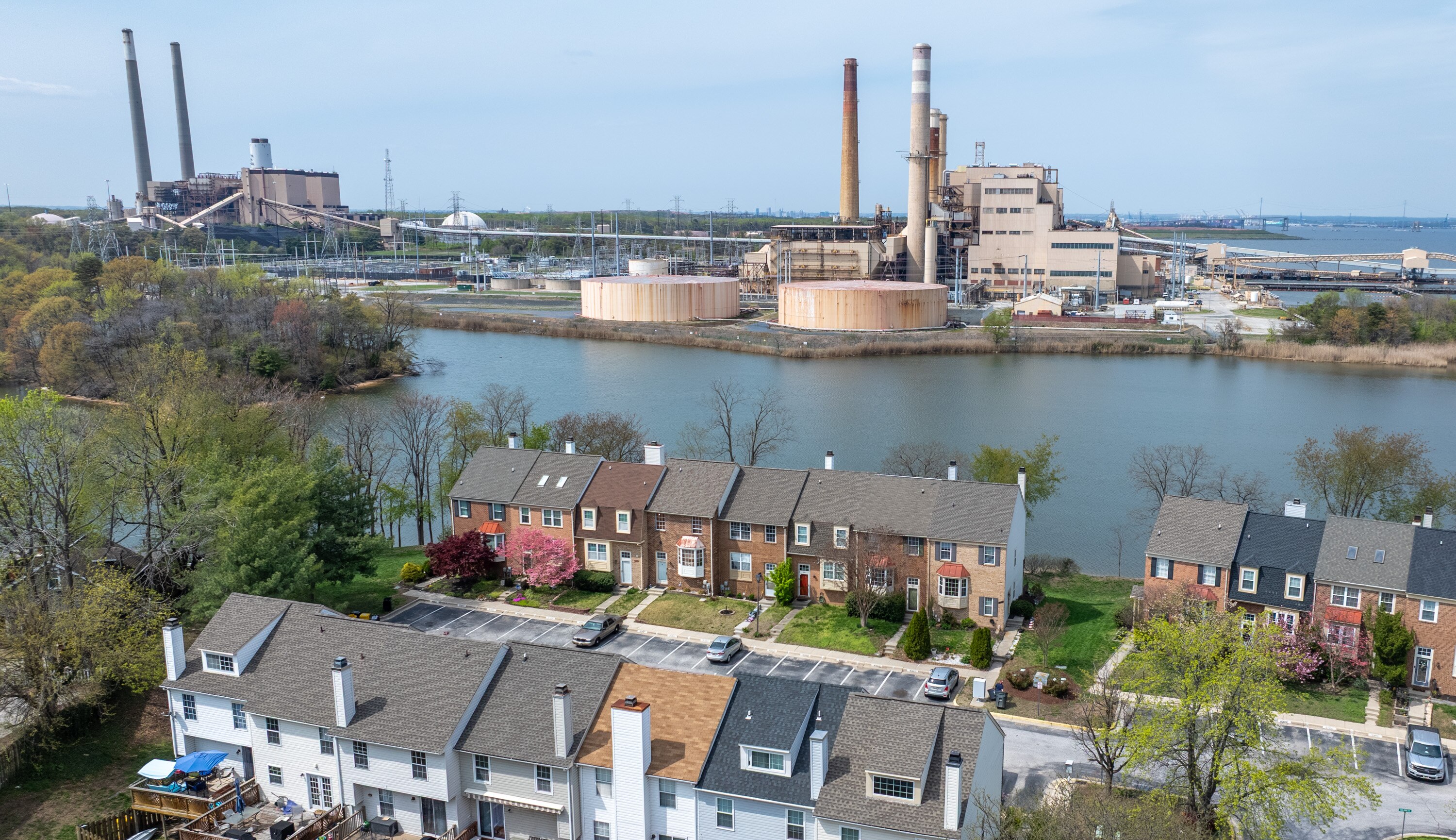 The Herbert A. Wagner Generating Station, foreground, and Brandon Shores Generating Station are seen across Cox Creek from homes in the Stoney Beach community.