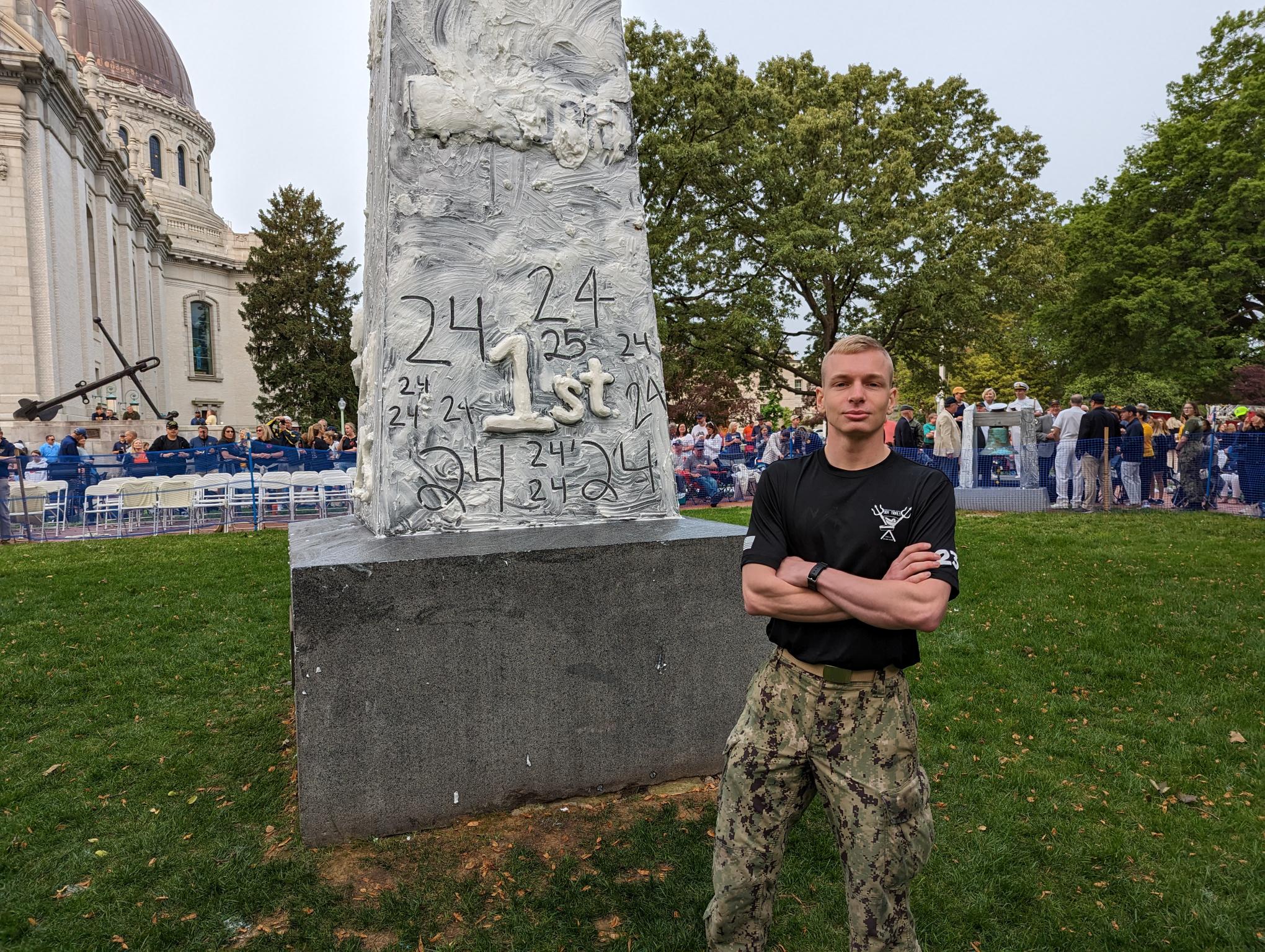 Midshipman Gabe Neale, commander of this year's Herndon Monument climb at the Naval Academy, poses in front of it before plebes began ascending it on May 17, 2023.