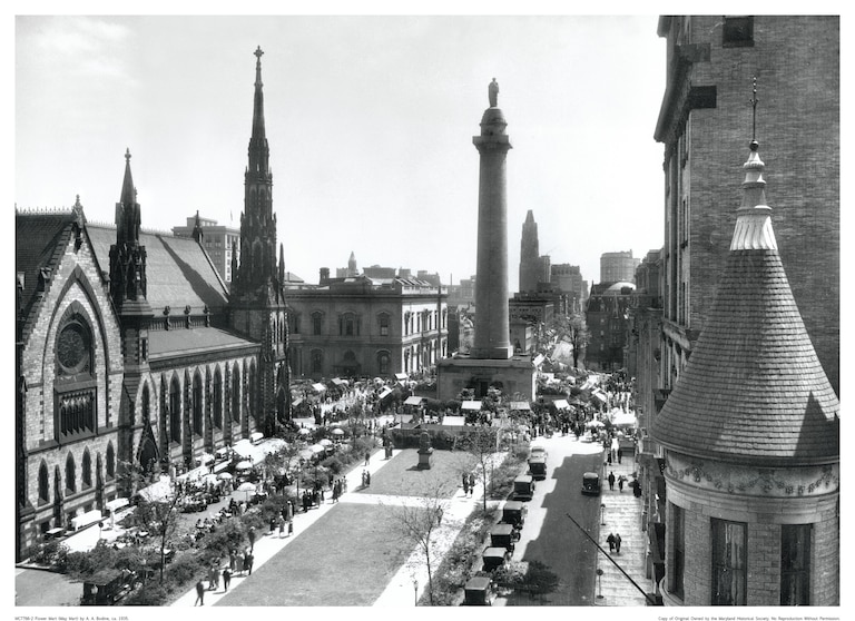 An elevated view of the Flower Mart (May Mart) from the Washington Apartments at 700 North Charles Street, Baltimore, Maryland. Shows the Washington Monument and the Methodist Church located at 2-8 Mt. Vernon Place. View is from the northwest corner of Charles and Madison Streets. The Flower Mart is an annual local festival founded by the Women's Civic League.