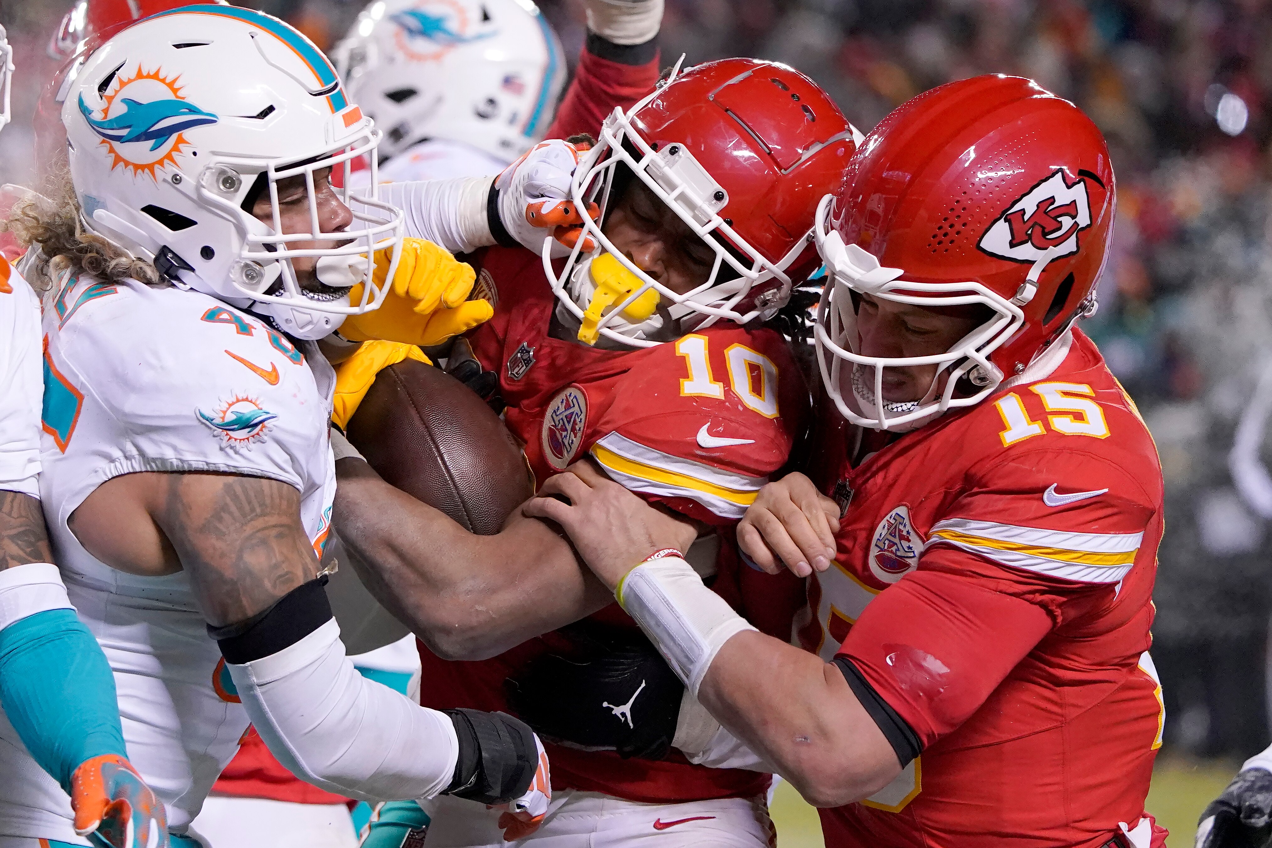 Chiefs running back Isiah Pacheco scores a touchdown between quarterback Patrick Mahomes and Miami Dolphins linebacker Duke Riley, left, during the second half.