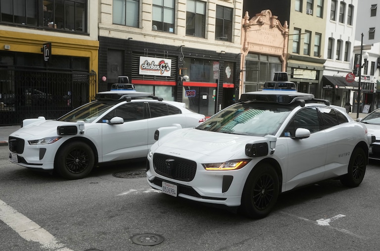 Waymo vehicles wait at an intersection in San Francisco, Wednesday, Oct. 22, 2025.