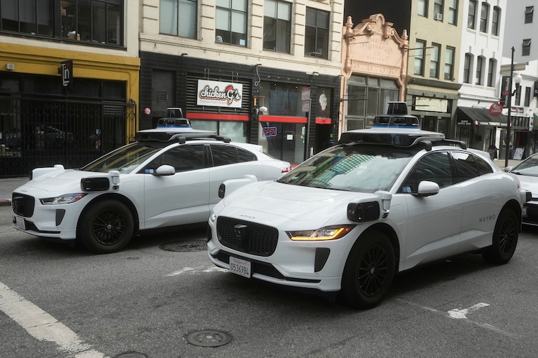 Waymo vehicles wait at an intersection in San Francisco, Wednesday, Oct. 22, 2025.