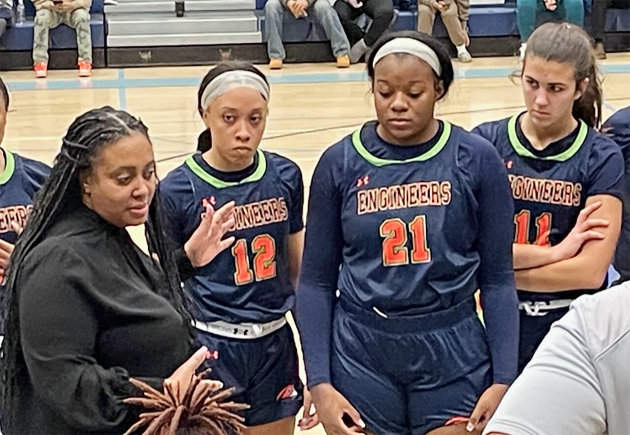 Poly coach Kendall Peace-Able talks to her team in the time-out huddle during the No. 2 Engineers' 54-50 victory over No. 4 St. Vincent Pallotti Saturday. Mickelle Lowry (12), who hit the game-winning 3-pointer, listens along with Sierra George (21) and Amelia Overton (11).
