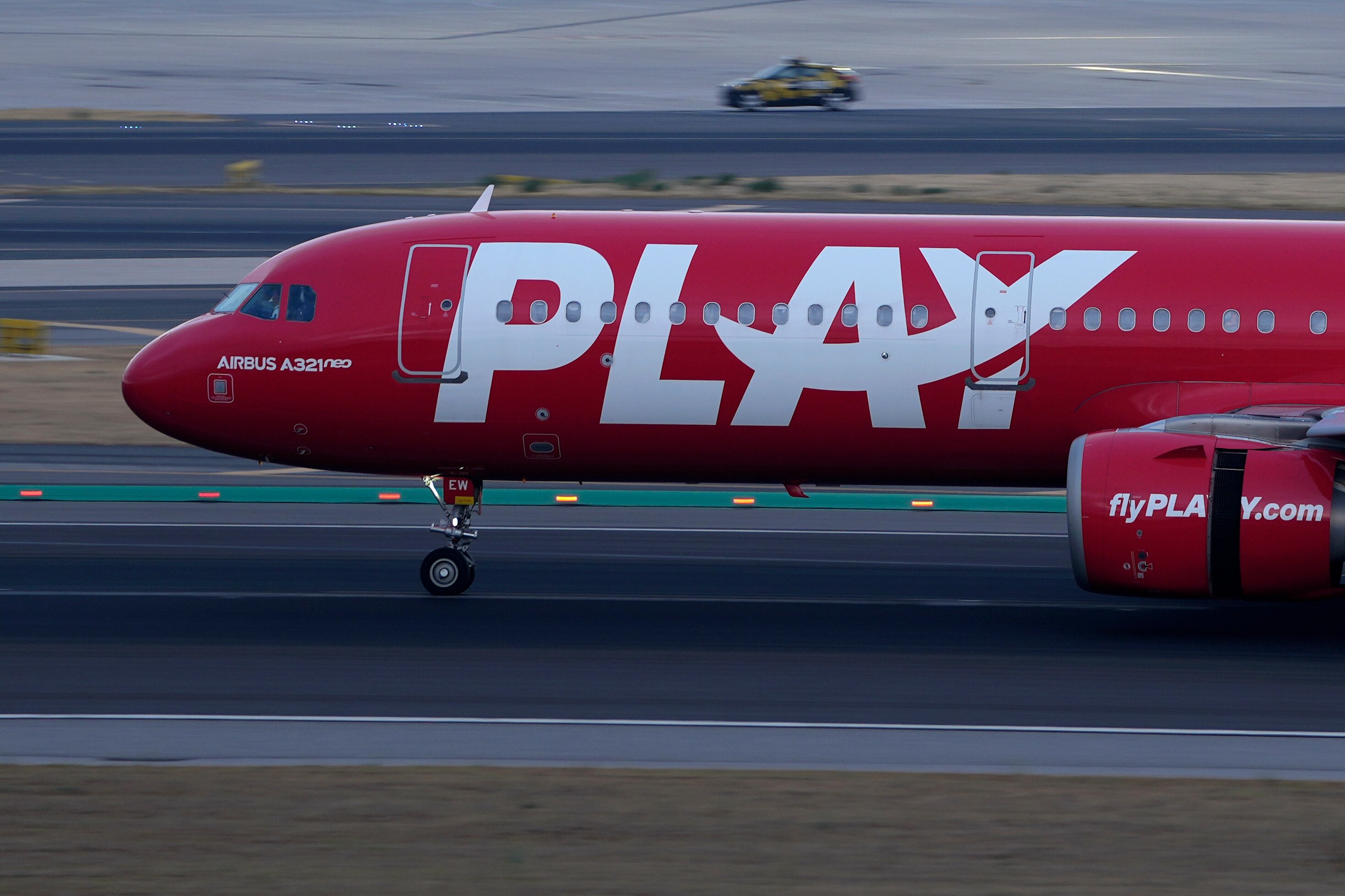 A Fly Play Airbus A321 lands at Lisbon airport, as night falls Friday, Aug. 26, 2022. (AP Photo/Armando Franca)