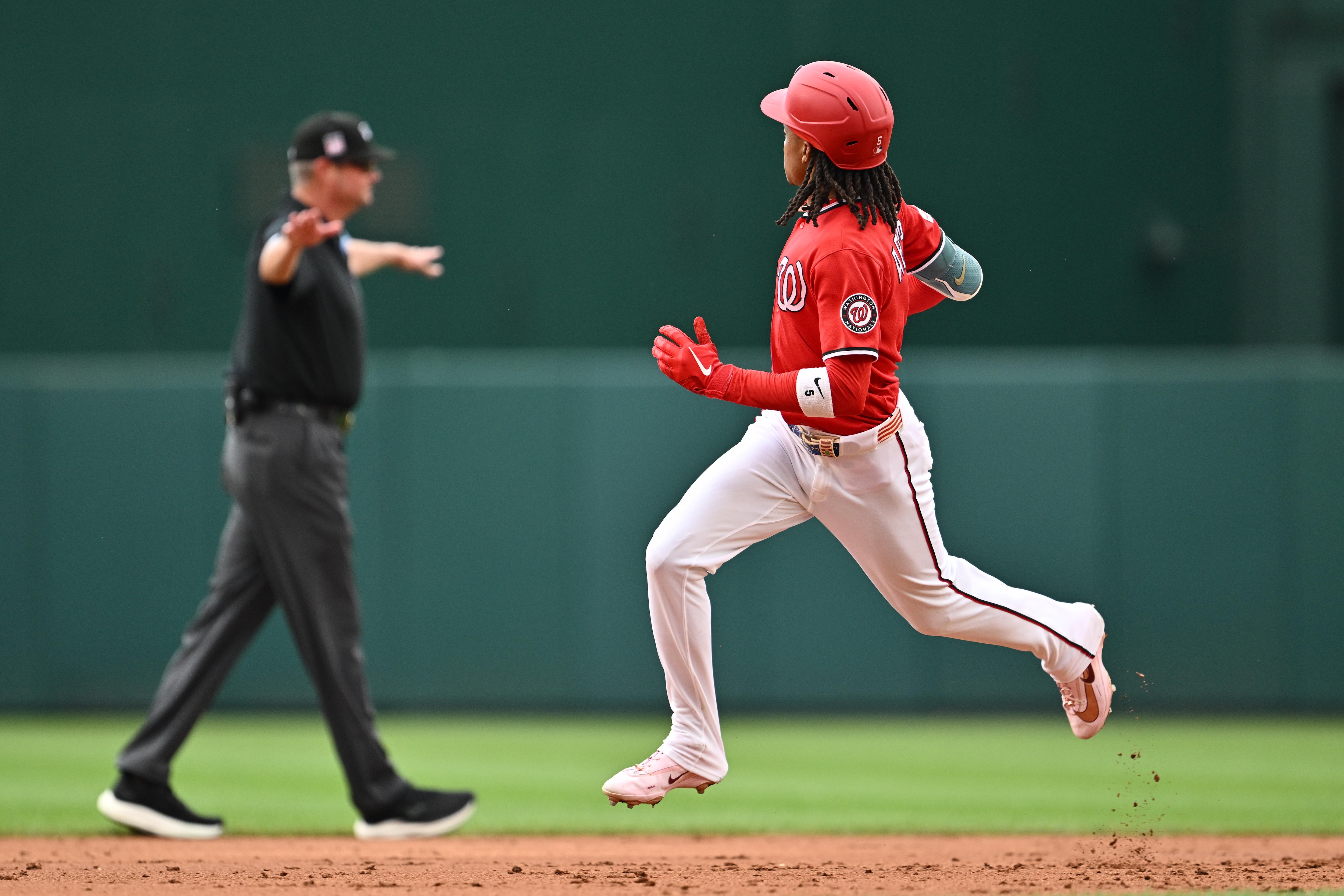 CJ Abrams breaks out of his trot as umpire Jordan Baker signals no home run in the third inning Sunday at Nationals Park. The call was changed to a home run after the Nationals challenged.