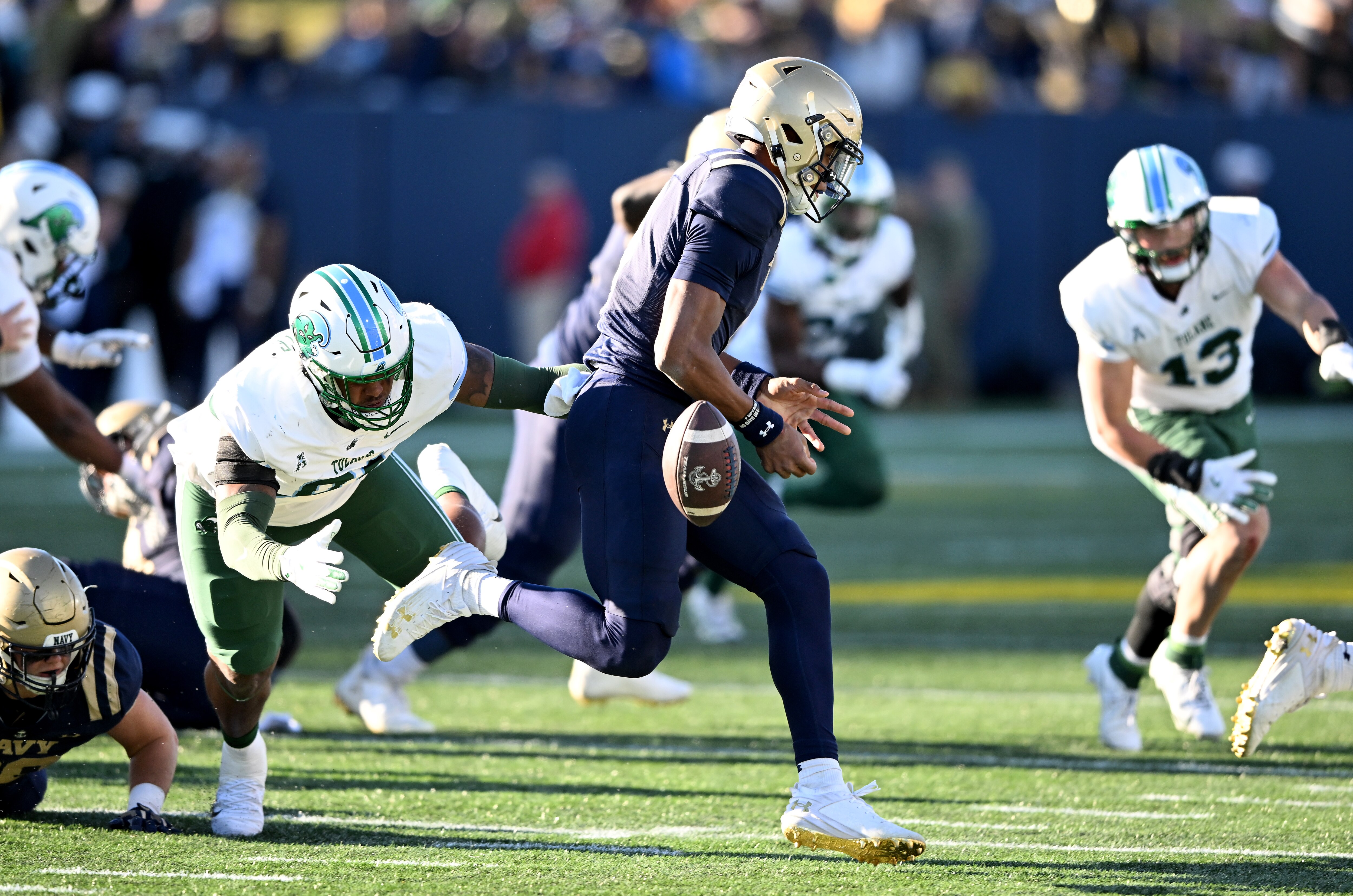 Deshaun Batiste of Tulane forces a fumble by Braxton Woodson of Navy on Saturday during the fourth quarter of the Green Wave victory.