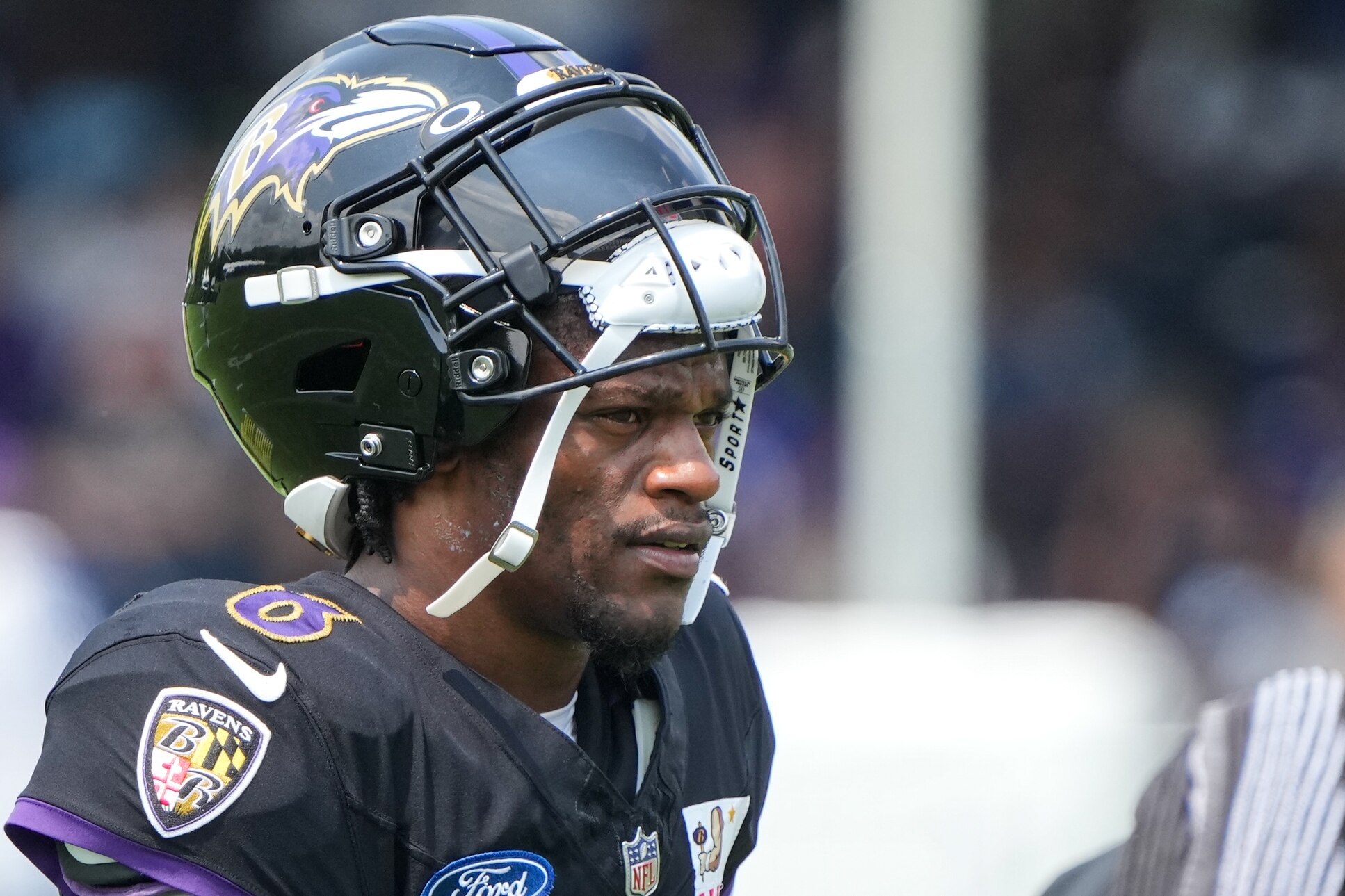 Baltimore Ravens quarterback Lamar Jackson (8) takes a break between drills during the team’s training camp practice at the Under Armour Performance Center in Owings Mills on Tuesday, August 6, 2024.