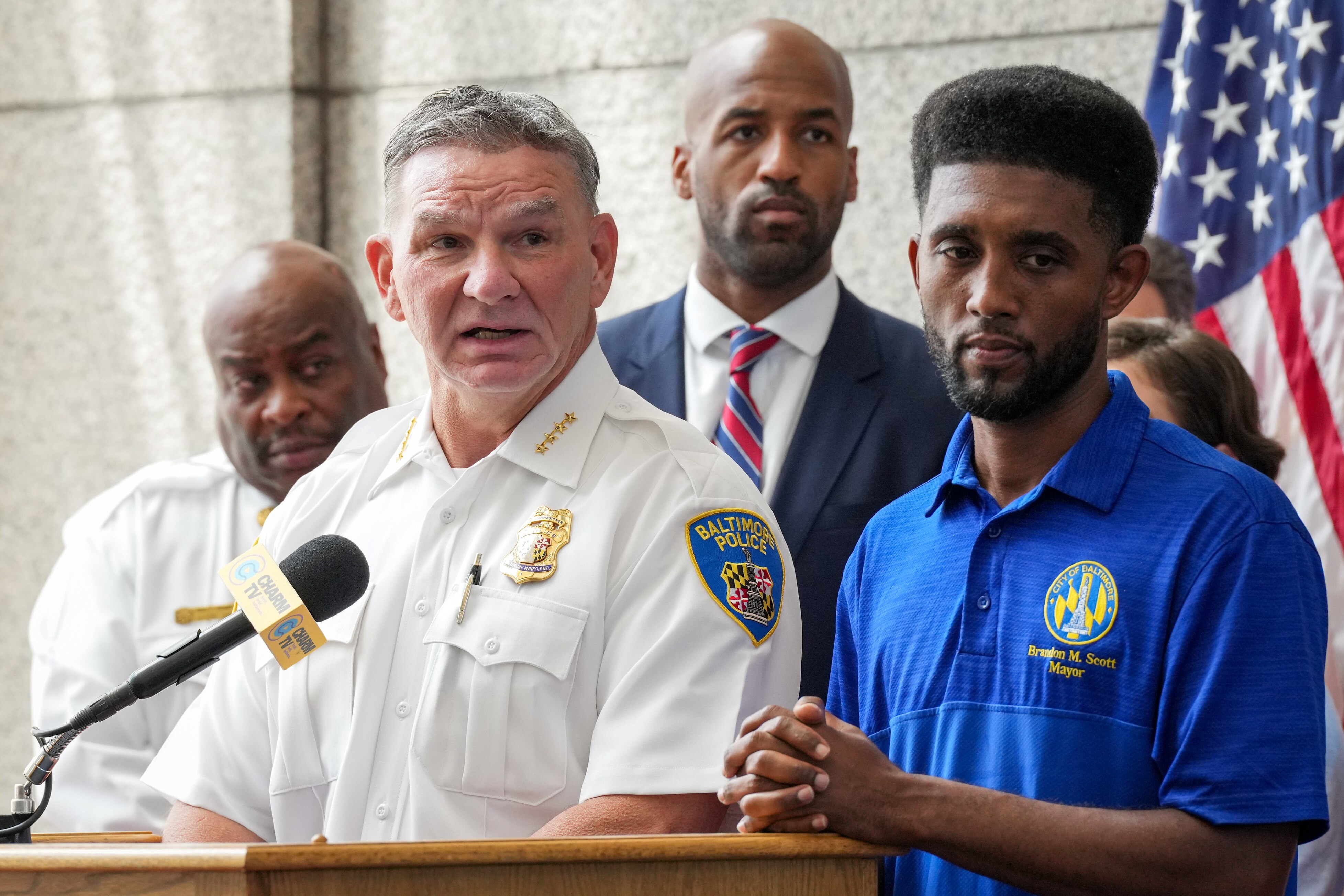 Acting Baltimore Police Commissioner Richard Worley, left, stands alongside Baltimore Mayor Brandon Scott, right, as he speaks at a news conference on Monday inside Baltimore Police Department Headquarters.