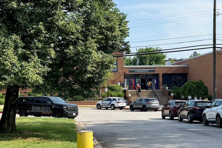 Baltimore Police vehicles are parked outside The Commodore John Rodgers School, which is temporarily holding classes in Dundalk, after a report that ICE (Immigration and Customs Enforcement) officers arrested a person during school drop-offs on Thursday morning.