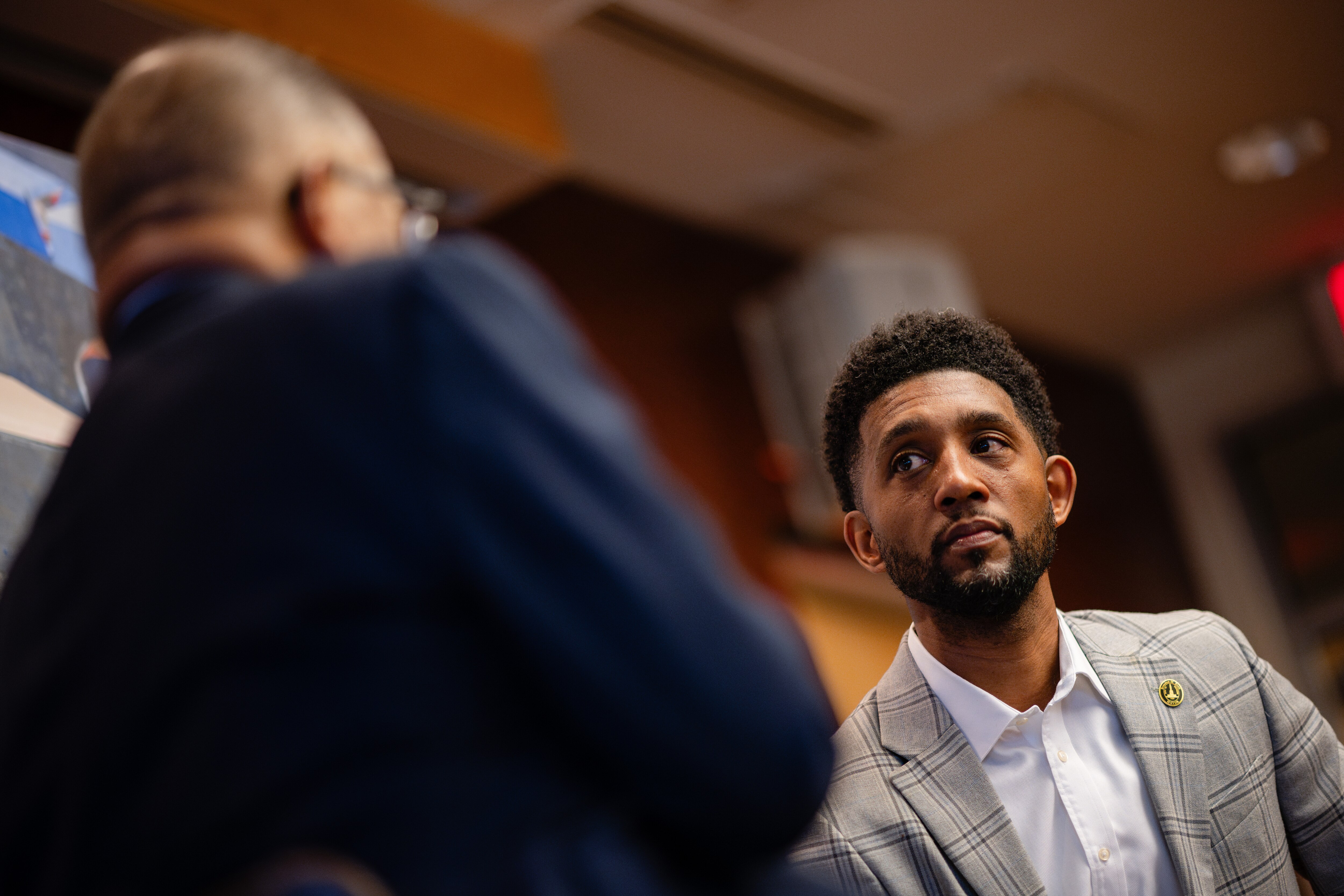 Baltimore Mayor Brandon Scott speaks with Dr. Benjamin Chavis, president of the National Newspaper Publishers Association/Black Press of America, during The Baltimore Uprising: 10 Years Later panel on Friday at the Reginald F. Lewis Museum of Maryland African American History & Culture.