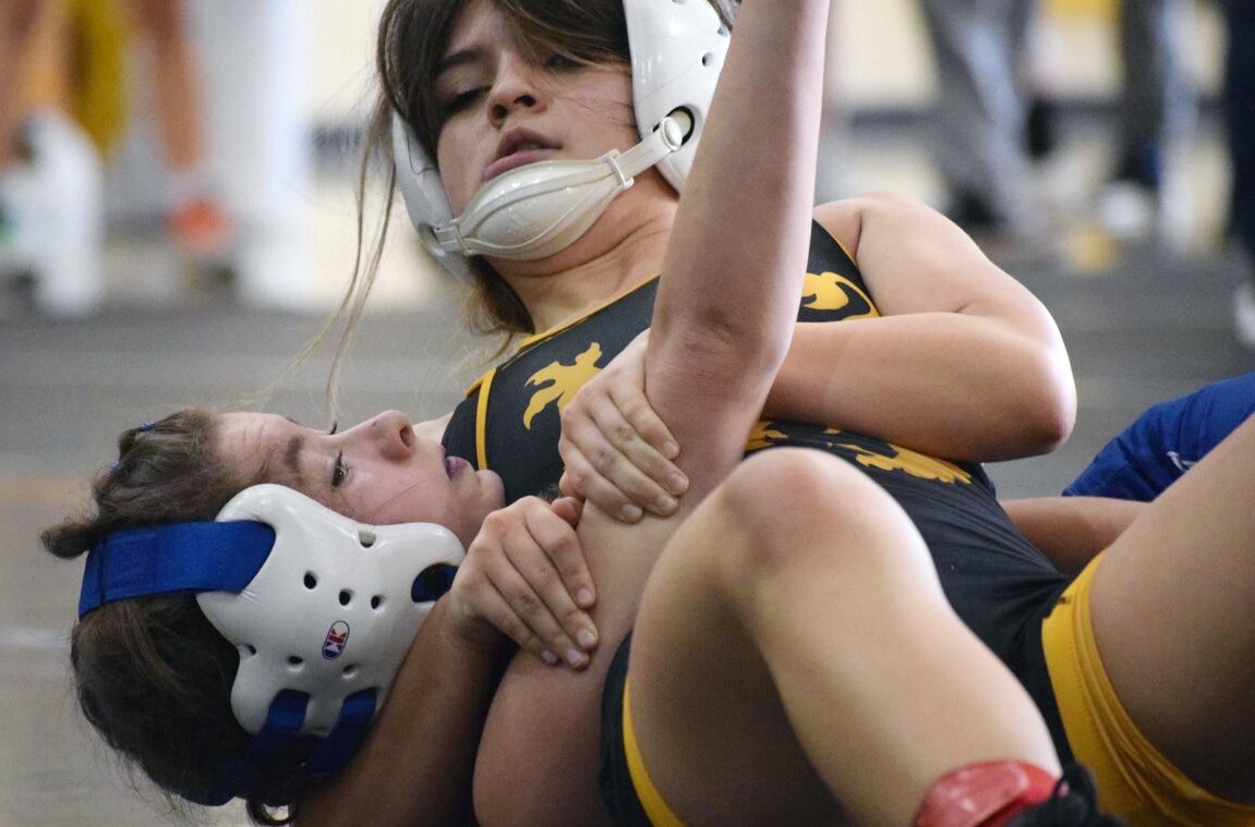Defending 100-pound state champion Ally Conley (top) of Queen Anne's County nails down one of her 10 falls on the year.