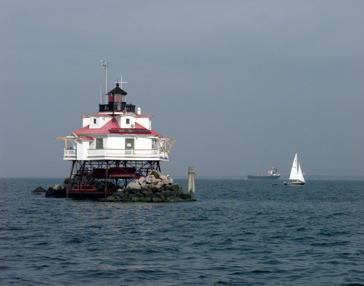 A sailboat cruises by the Thomas Point Shoal Light near Annapolis. The 140-year-old lighthouse is one of four sites proposed for a new national park on the Chesapeake Bay.