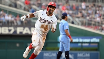 Washington Nationals' Nasim Nuñez, left, heads home to score on an RBI double by Luis García Jr. during the second inning.