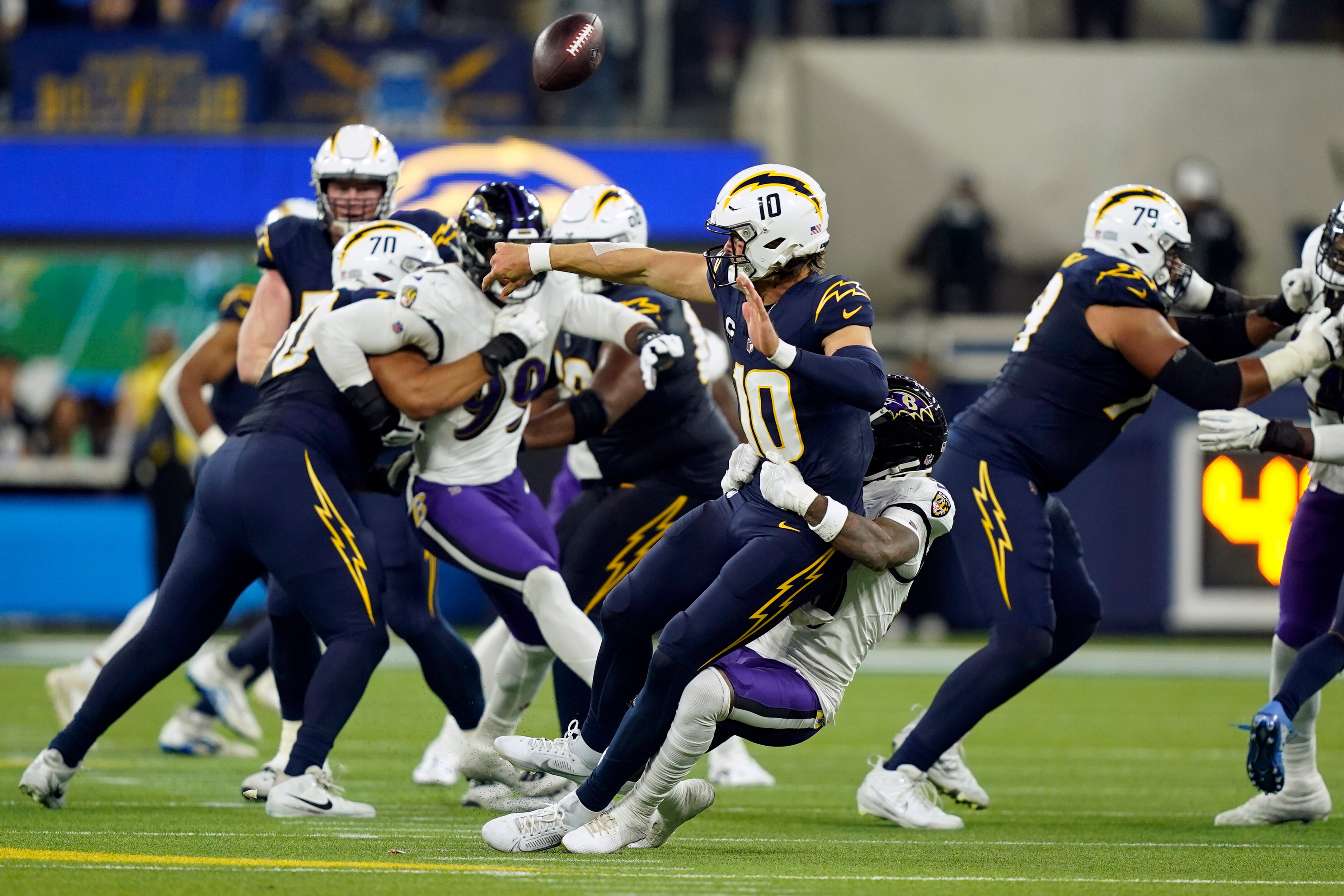 Los Angeles Chargers quarterback Justin Herbert (10) is sacked by Baltimore Ravens cornerback Arthur Maulet on fourth down during the second half of an NFL football game on Sunday, Nov. 26, 2023, in Inglewood, California.
