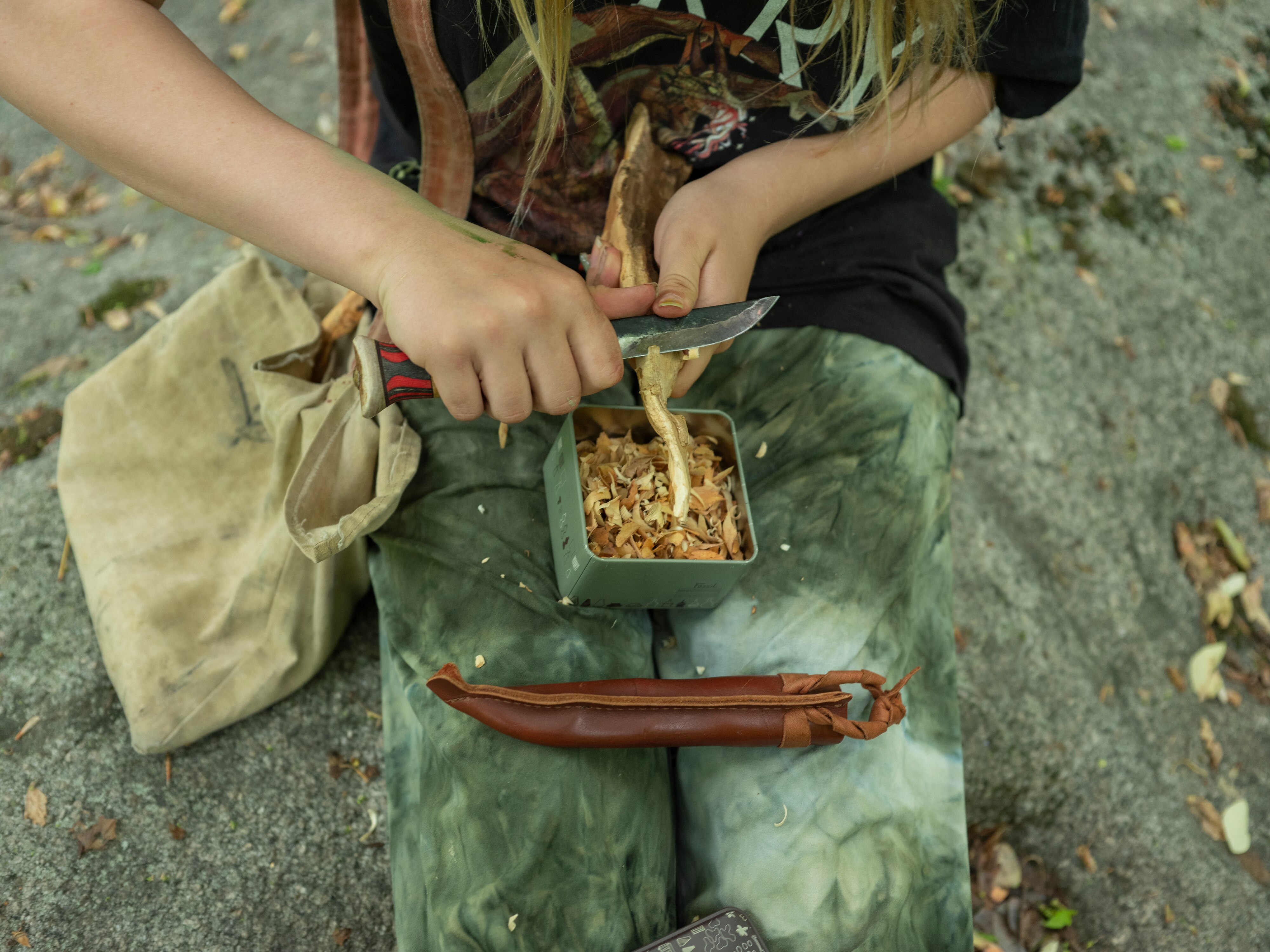 ELLICOTT CITY, MARYLAND - May 18, 2022: Linnea Tarr carving sassafras root found while foraging her property in Ellicott City, Maryland, on Tuesday May 18, 2022. Many people have taken up foraging since the start of the pandemic, inspired by walks in the woods and a more DIY approach to cooking CREDIT: Andrew Mangum for Baltimore Banner