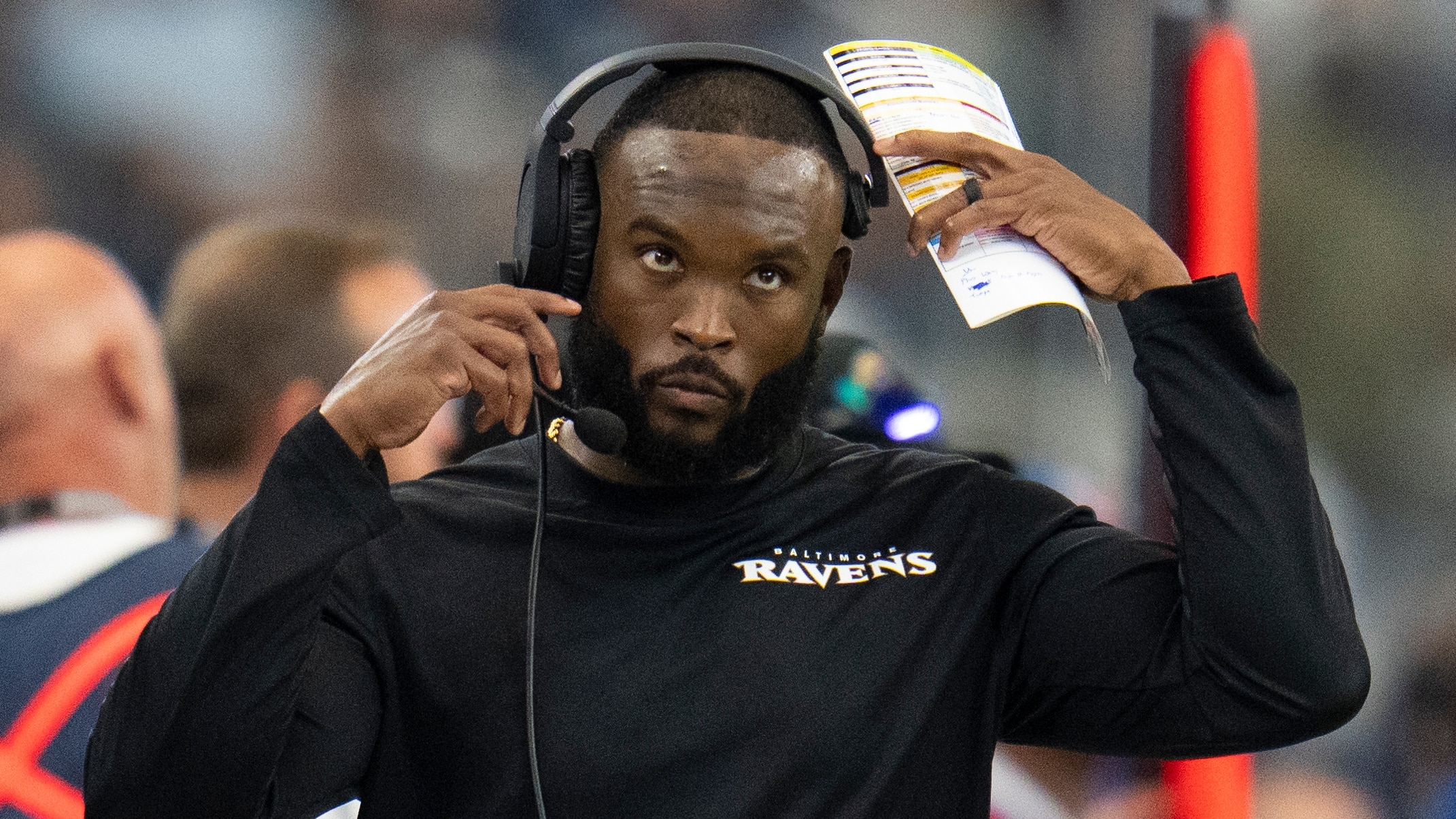 Ravens defensive coordinator Zachary Orr looks at the scoreboard during a game against the Dallas Cowboys.
