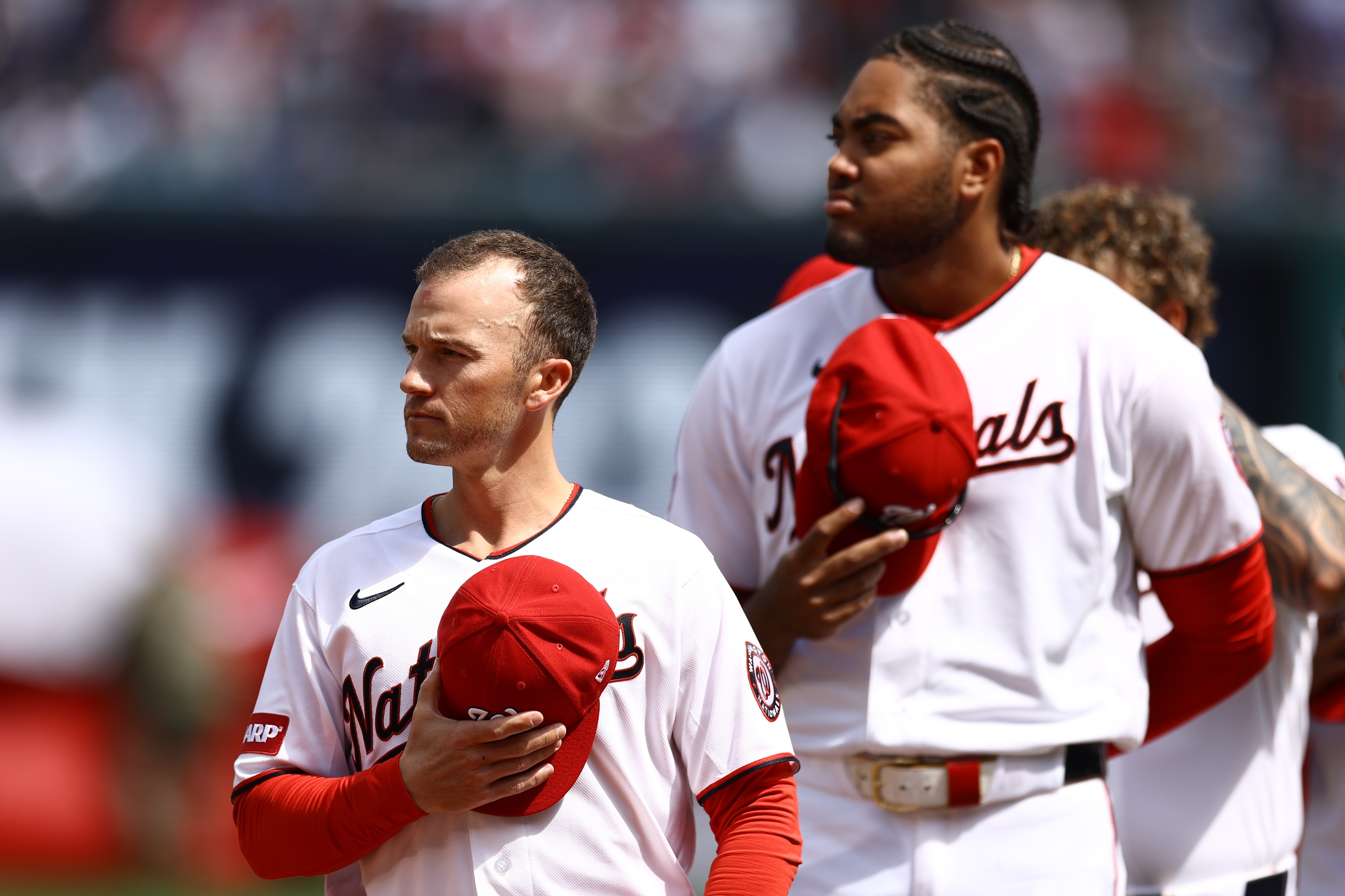 Washington Nationals manager Blake Butera, left, stands at attention before the team's home opener against the Los Angeles Dodgers on Friday.
