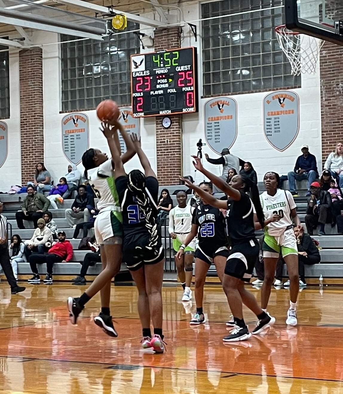 Forest Park freshman Shakira Mitchell (5) takes a shot over Mount Carmel's Dania Madden (33) at the Public vs. Private Challenge Saturday at McDonogh. The No. 7 Cougars pulled away from a tie at the start of the fourth quarter to win 42-38 over the 10th-ranked Foresters.