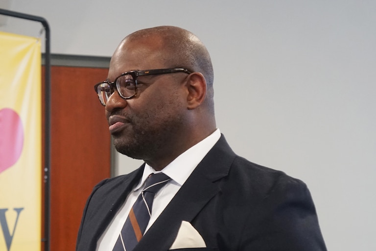 Chad Williams, executive director of the West North Avenue Development Authority, speaks with an attendee after sitting for a panel discussion on Jan. 24 at Live Baltimore's State of the City Market Update at Coppin State University.