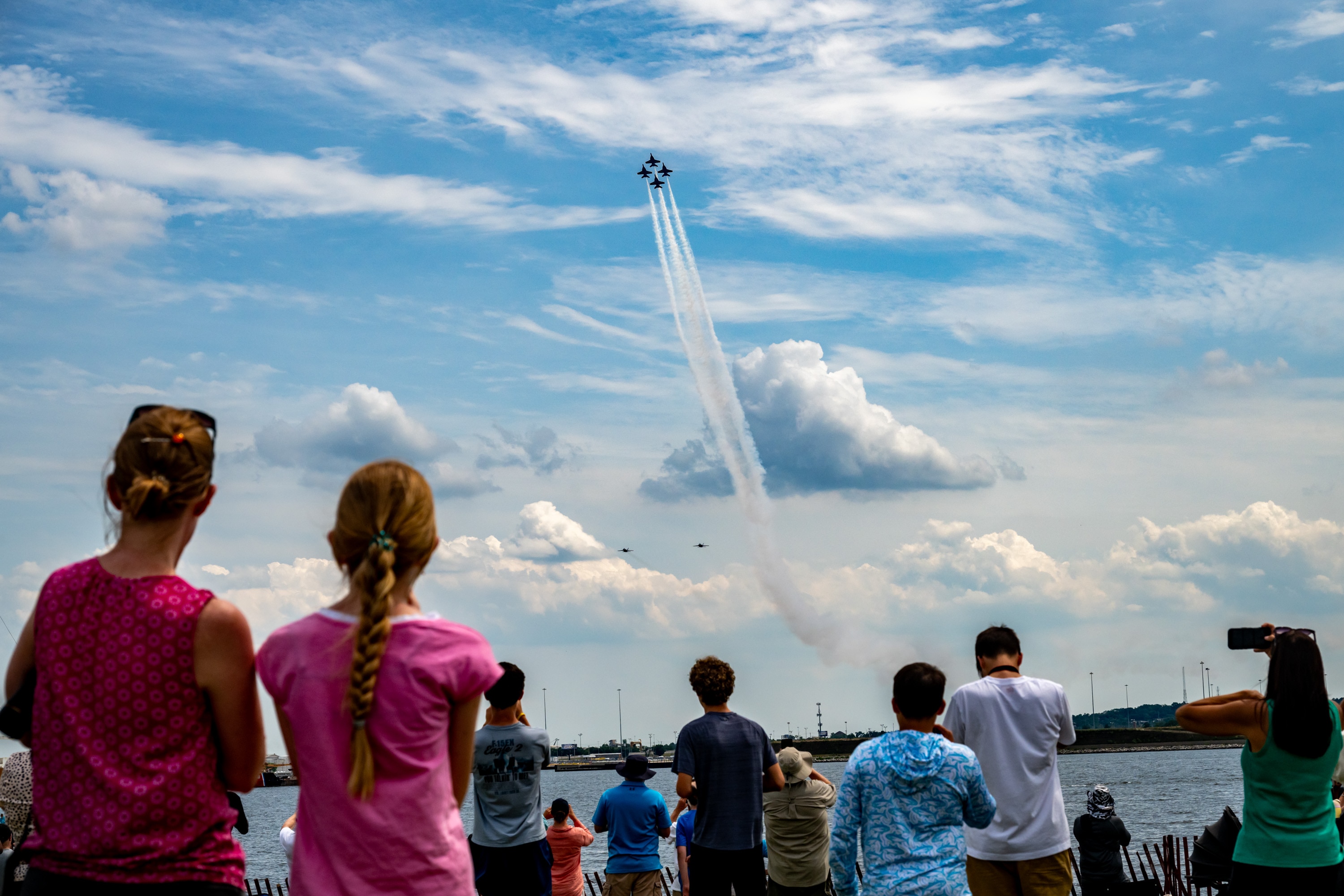 Spectators at Fort McHenry watch the Blue Angels practice their Sail250 show on Friday.