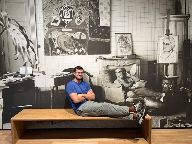 Anne Arundel County native and international artist Louis Fratino poses next to an image of Henri Matisse at the Baltimore Museum of Art.