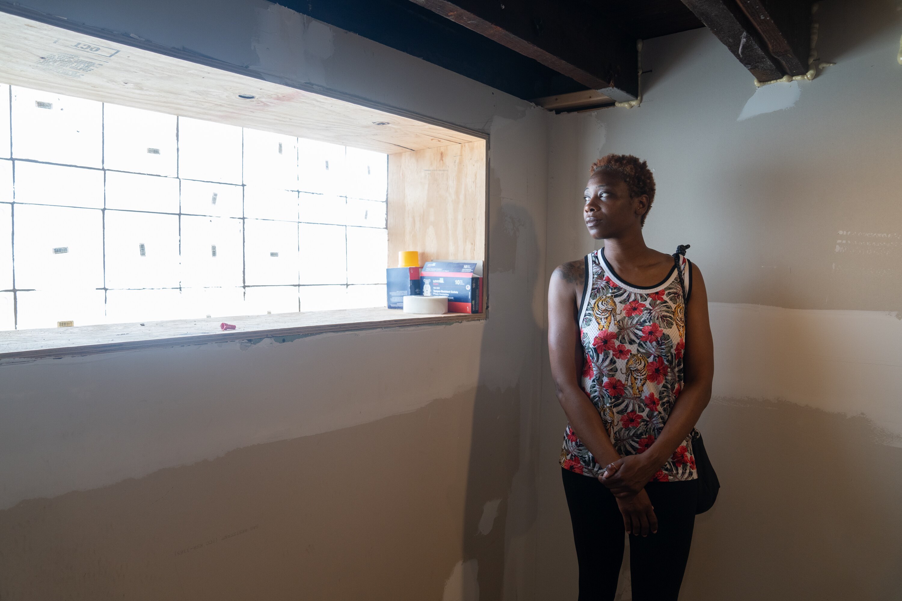 Tahera Arrington, a resident of Midtown-Edmondson, in the basement of her damaged home. Her neighborhood has turned into a construction site as Amtrak prepares to build the western entrance of the future Frederick Douglass Tunnel.