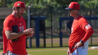 Washington Nationals pitcher Miles Mikolas talks to bullpen coach Dustin Glant (68) during a spring training practice in February.