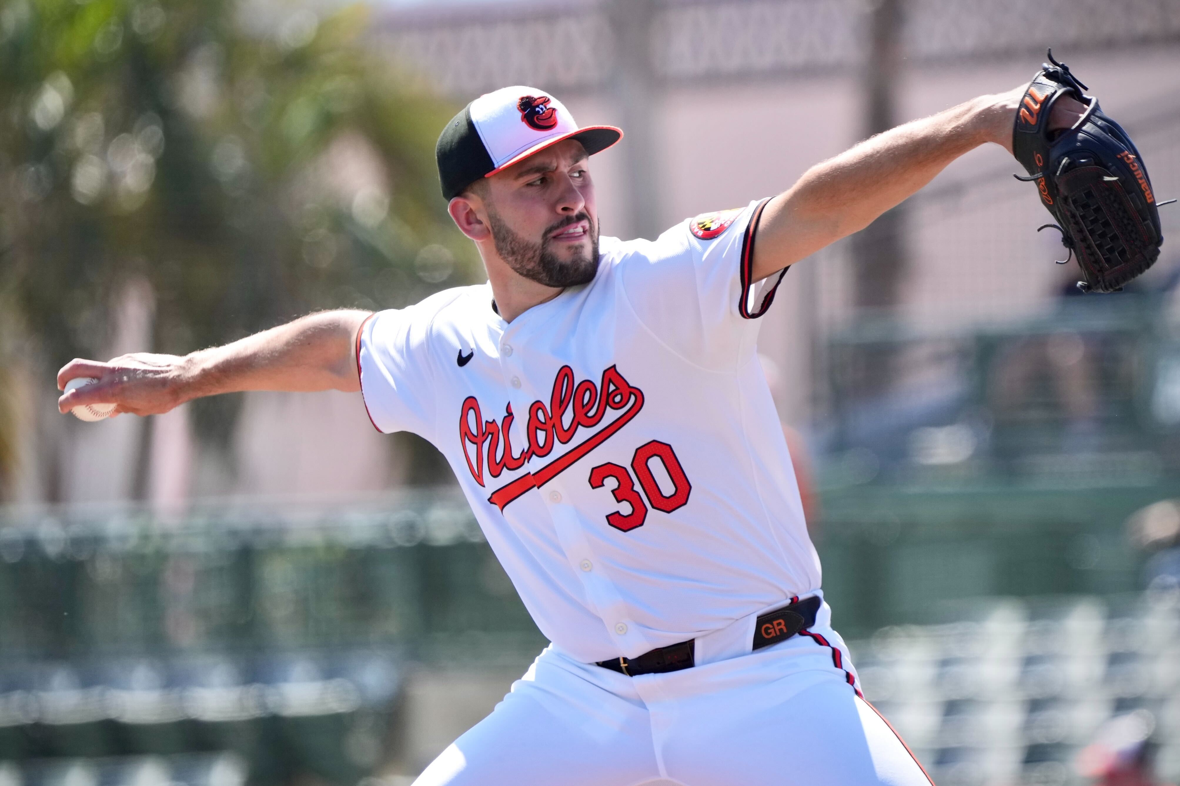 Orioles starting pitcher Grayson Rodriguez  delivers a pitch against the Detroit Tigers during a spring training game.