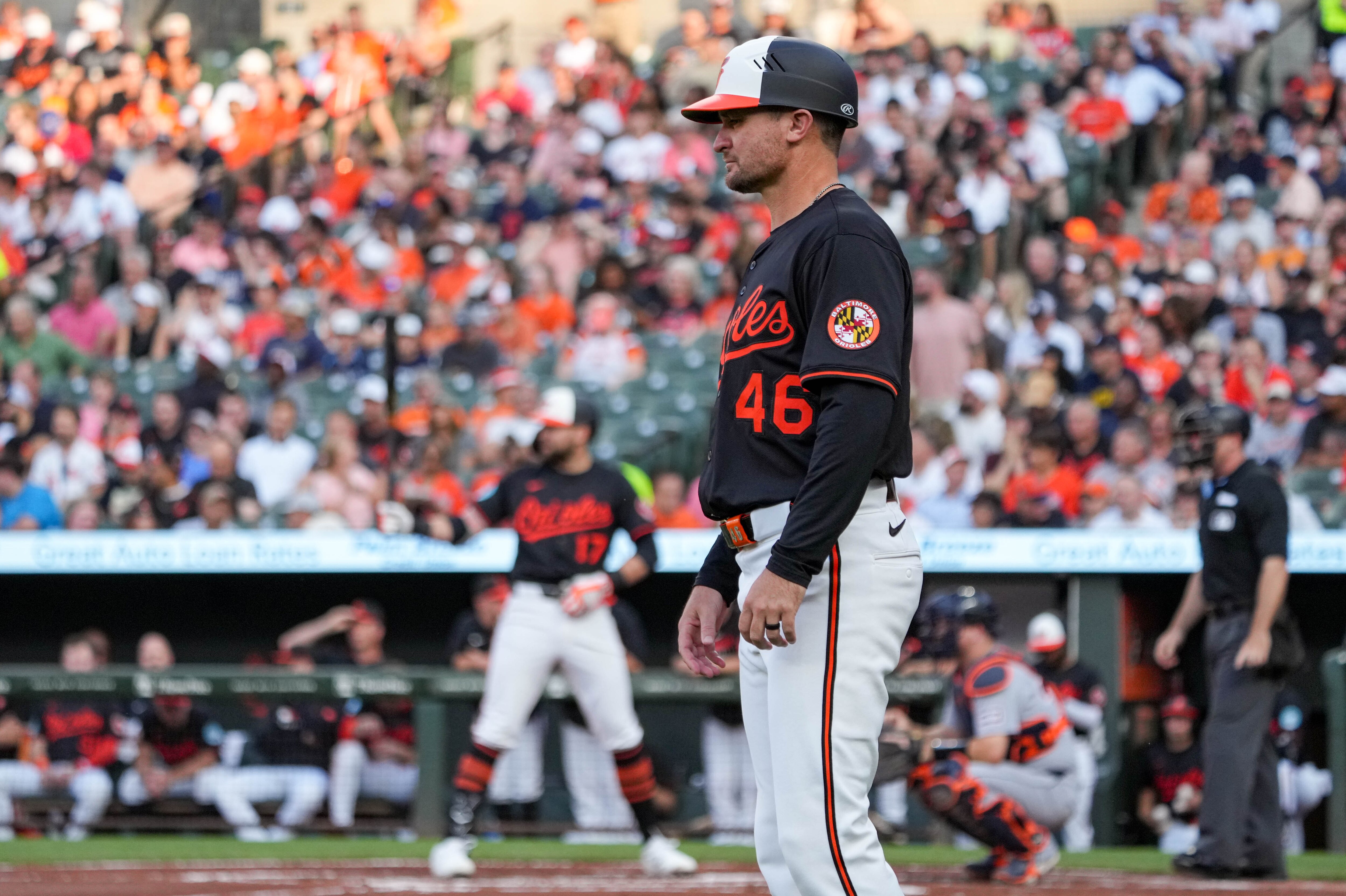 Baltimore Orioles interim third base/infield coach Buck Britton (46) observes the game as outfielder Colton Cowser (17) takes his at-bat during a game against the Detroit Tigers at Oriole Park at Camden Yards in Baltimore, Md. on Wednesday, June 11, 2025.