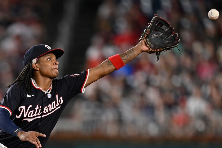 Washington Nationals shortstop CJ Abrams fields a wild throw from Nationals second base Luis García Jr. during a failed double play attempt during the eighth inning of a baseball game against the New York Yankees, Tuesday, Aug. 27, 2024, in Washington. (AP Photo/John McDonnell)
