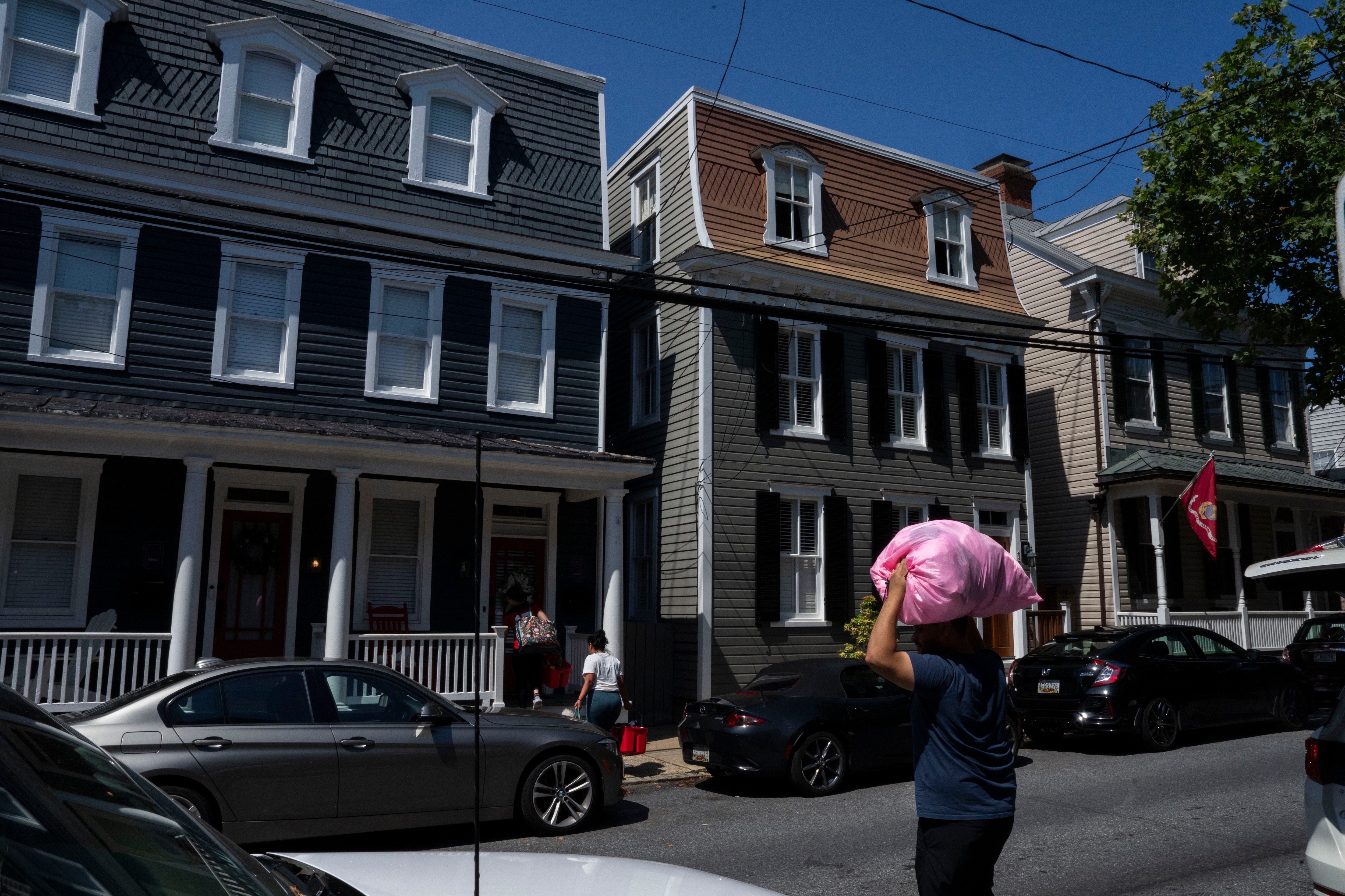 A cleaning crew works on a house in Annapolis that is set up for short-term rentals on I-Day, when parents come to visit their children at the Naval Academy — a popular time for bookings.