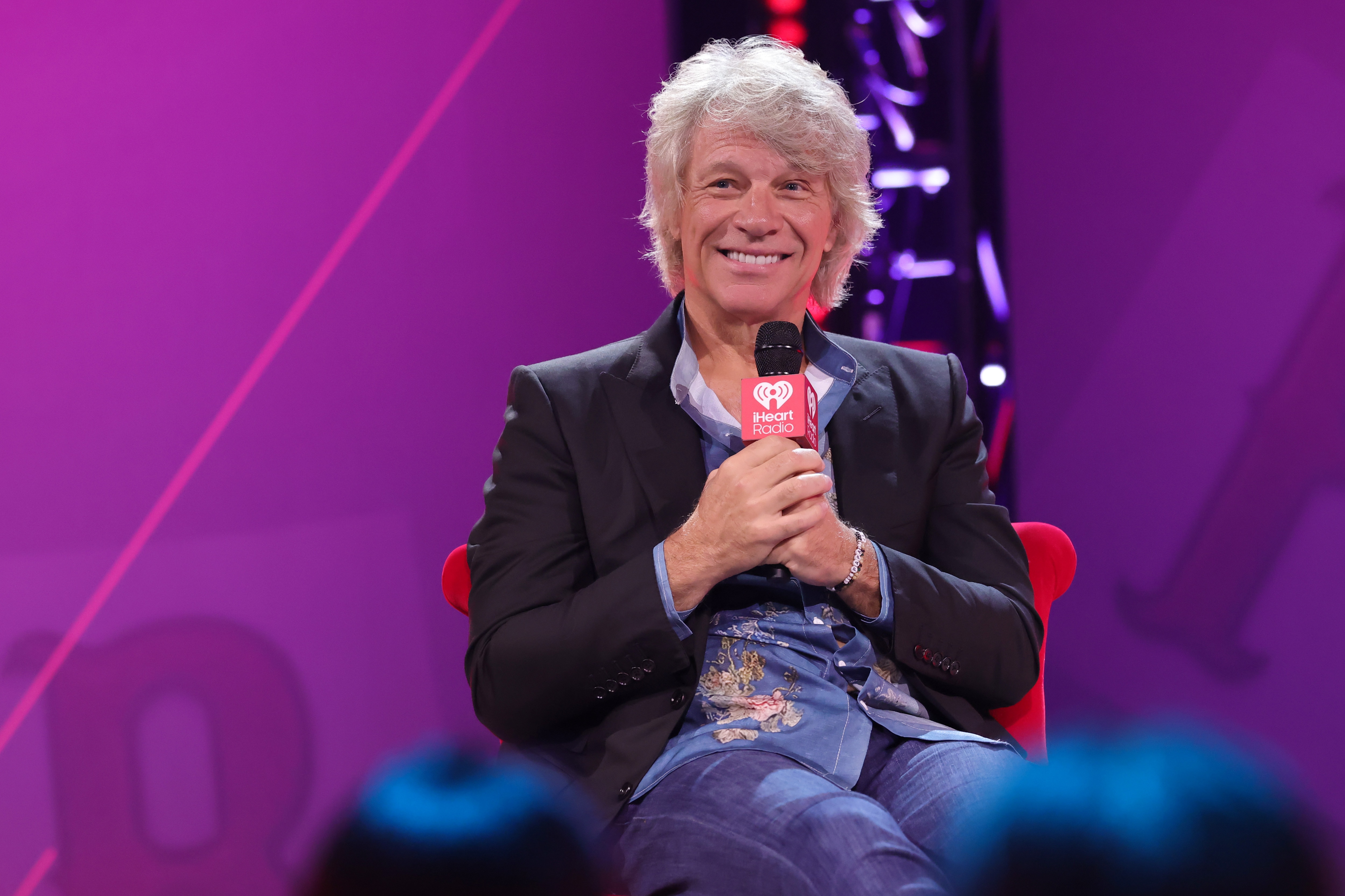 BURBANK, CALIFORNIA - OCTOBER 09: Jon Bon Jovi speaks onstage during the iHeartRadio album preview featuring Bon Jovi's "Forever" (Legendary Edition) at iHeartRadio Theater on October 09, 2025 in Burbank, California. (Photo by Kevin Winter/Getty Images for iHeartRadio)